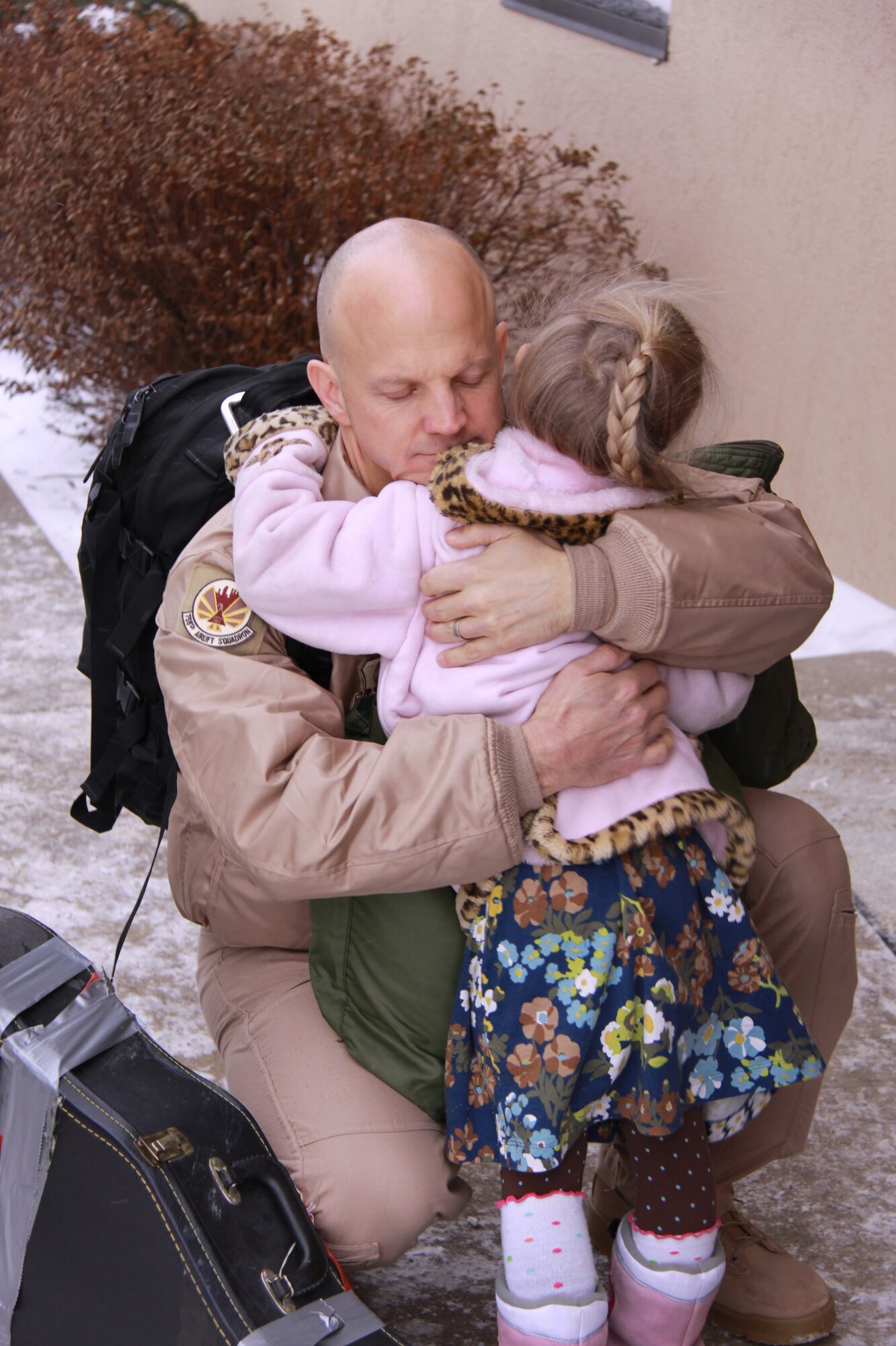Maj. Shawn Donahey, 758th Airlift Squadron, gives daughter, Molly, a big hug before
departing for a four-month deployment in support of Overseas Contingency
Operations. The deployment will involve multiple aircrews and aircraft, as well as
numerous maintenance personnel and support functions to various locations
throughout the Area of Responsibility.
