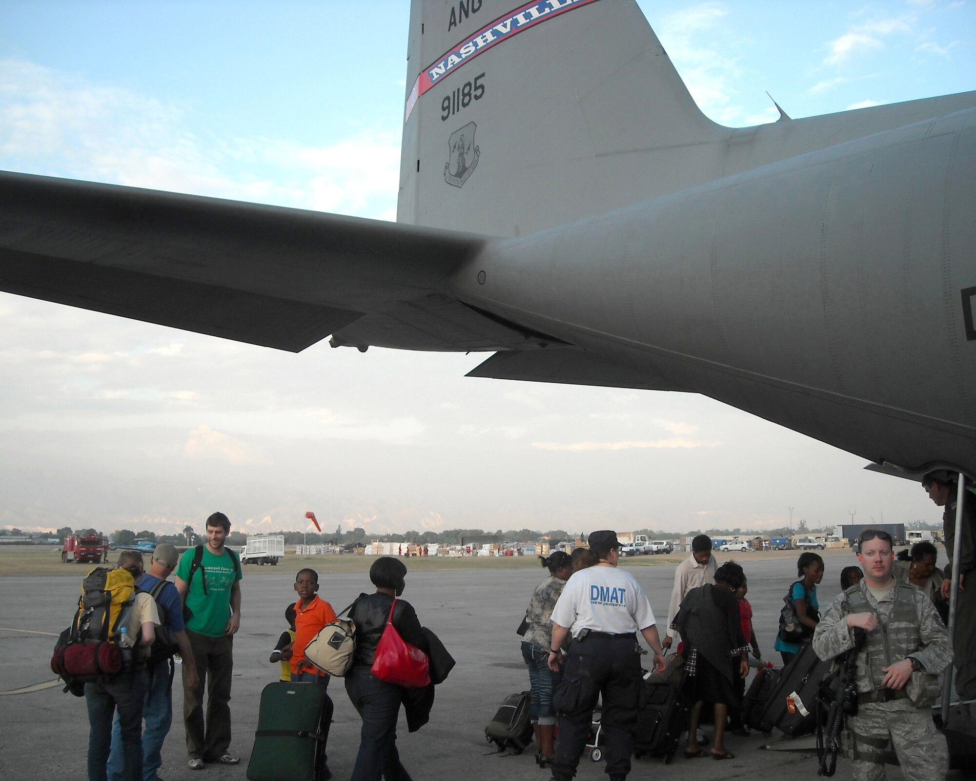 People board one of two 118th Airlift Wing C-130s, January 19, in Haiti to head back to the United States.