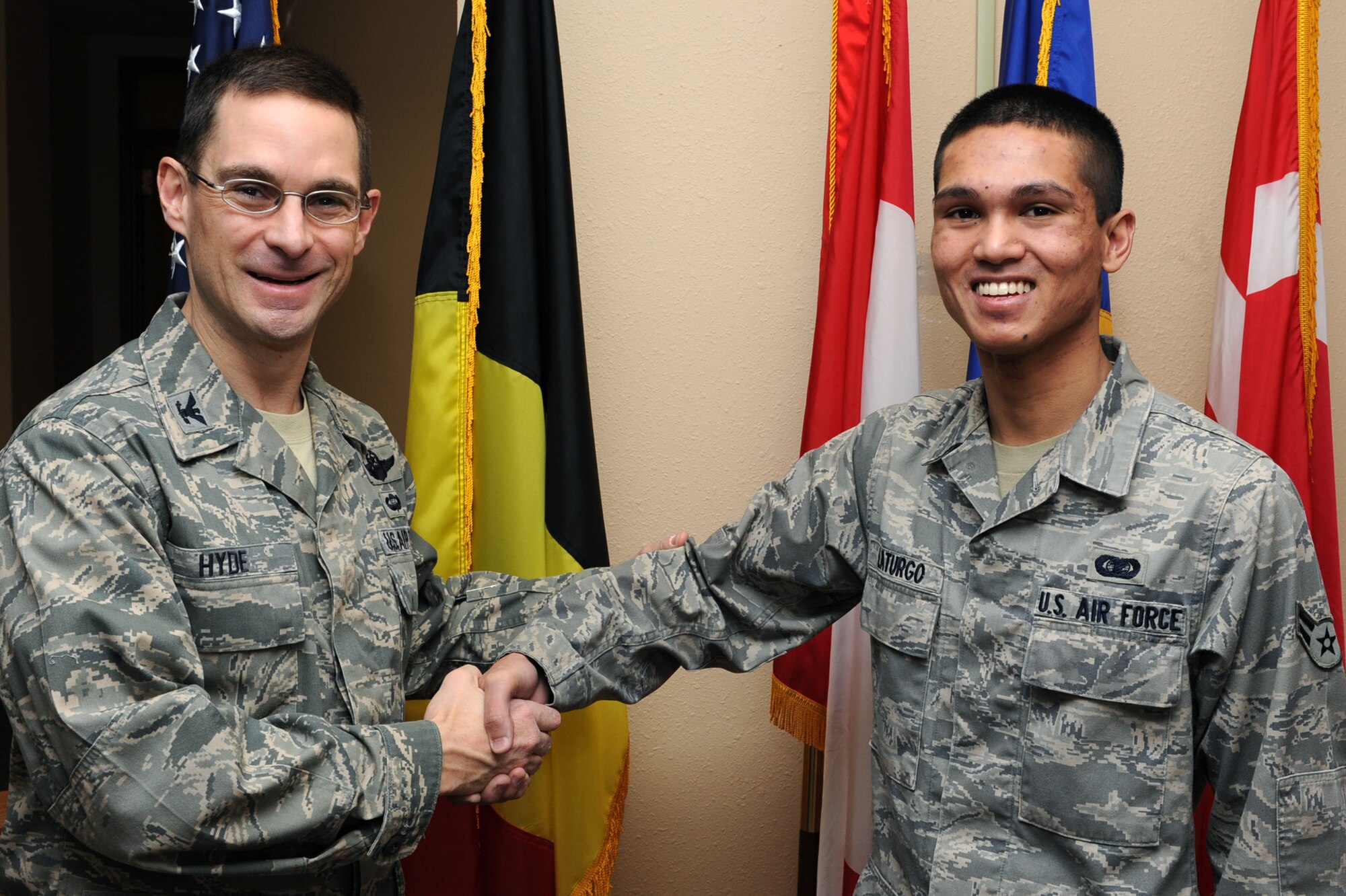 Col. C. K. Hyde, 314th Airlift Wing commander, presents Airman 1st Class Nordavid Laturgo, 714th Training Squadron student administrator apprentice, with a commander’s coin Feb. 3 for being selected as the Combat Airlifter of the Week. Airman Laturgo processed 425 student pass and leave forms for Christmas and New Year's break and maintained up-to-date contact information. (U.S. Air Force photo by Senior Airman Ethan Morgan)