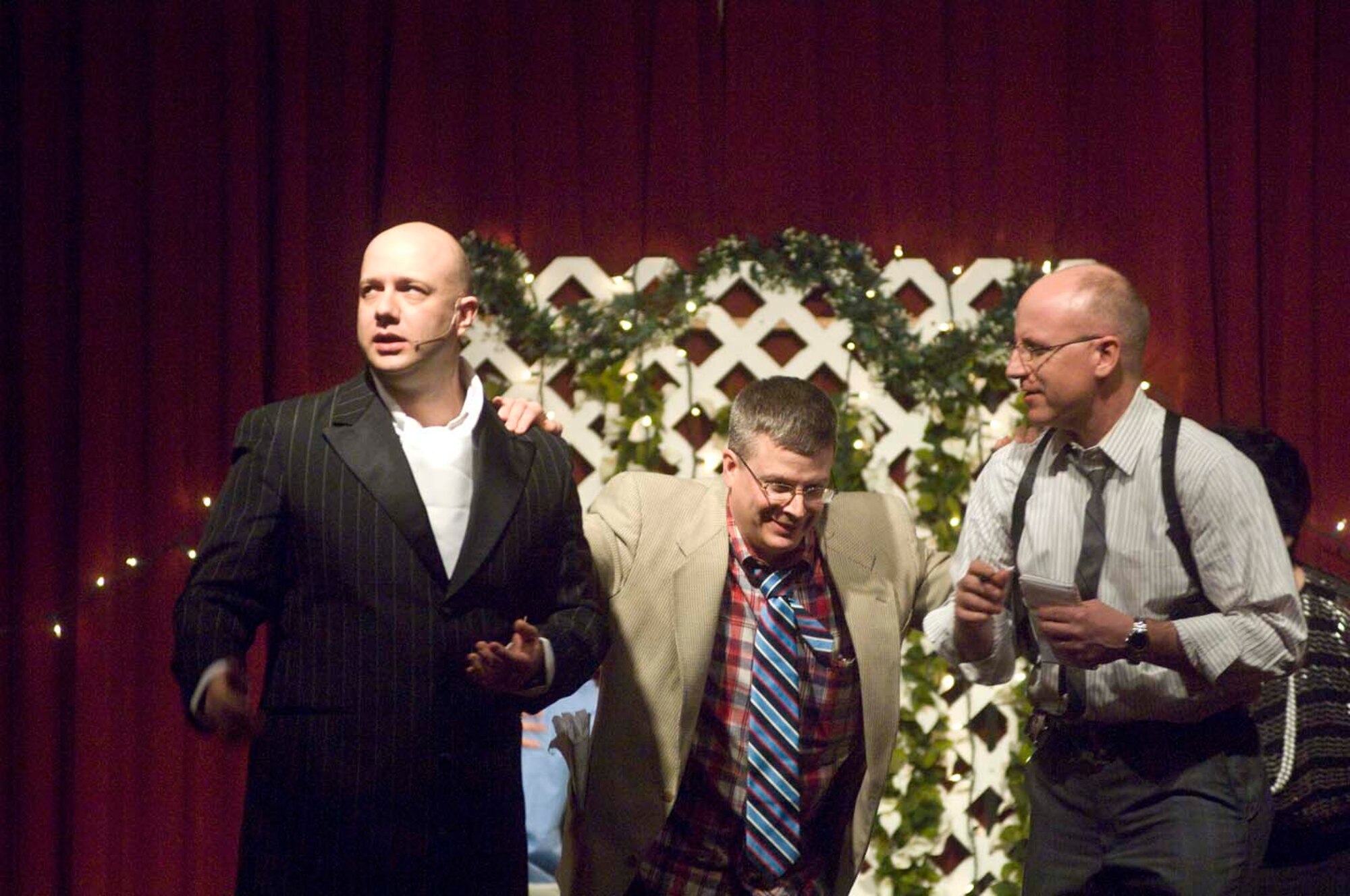 HANSCOM AIR FORCE BASE, Mass. – Fritz Fontaine (left), played by Capt. Dave Alpar, Air Force Band of Liberty commander, looks away as Henry Figgins (center), portrayed by Col. Charles Thompson, 66th Air Base Wing vice commander, keeps interrupting Detective Mamet, played by Col. William Leister,  950th Electronic Systems Group/EW division chief, in the stage play “Murder Me Always.” The performance, directed by Col. Bill Cooley, 350th Electronic Systems Group commander, and his wife, Janet, was performed at the Minuteman Club as part of the Murder Mystery night sponsored by the Hanscom Spouses Club.  (U.S. Air Force photo by Mark Herlihy)