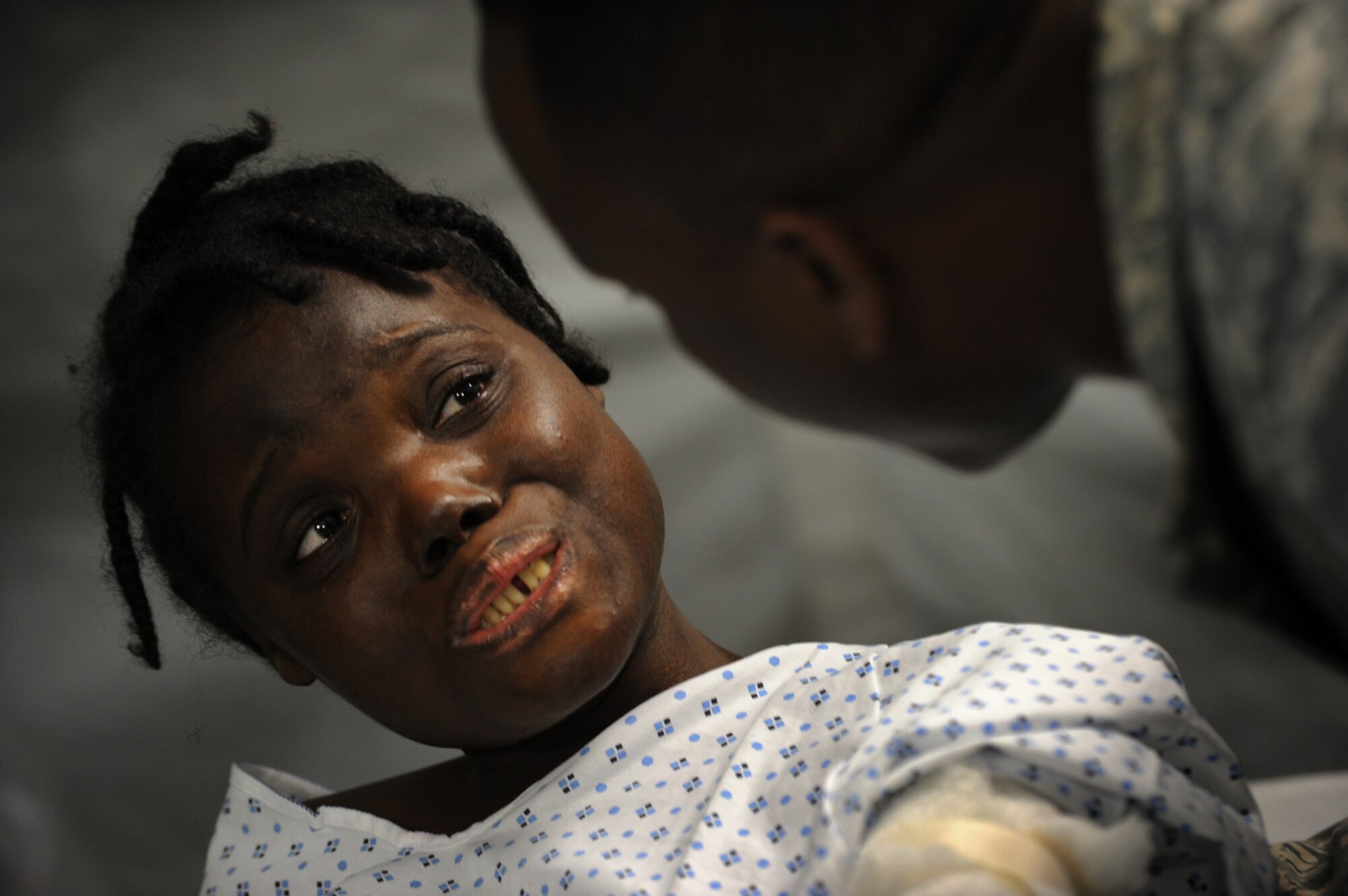 PORT-AU-PRINCE, Haiti - Airmen attached to Air Force Expeditionary Medical Squadron, Four Three Six, from Travis AF Base, Sacramento Cali., and Navy Corpsman treat earthquake survivors at an expeditionary medical facility located along the harbor of Port-au-Prince, Haiti February 3, 2010. A 7.0 earthquake Tuesday, January 12, left thousands of Haitians displaced, without access to food, water and vital medical care. (U.S. Navy Photo by Mass Communication Specialist 2nd Class Todd Frantom)