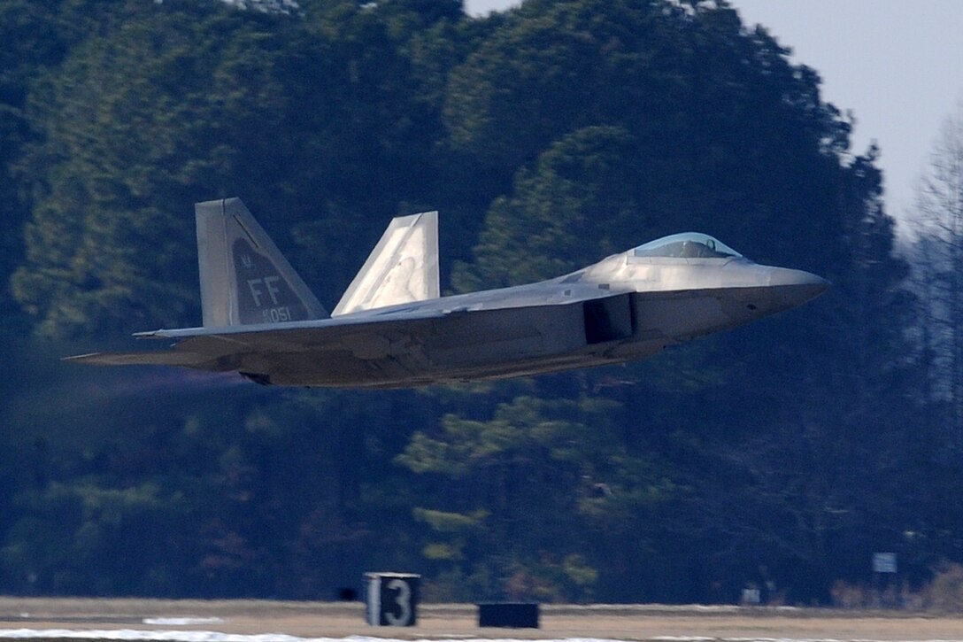 LANGLEY AIR FORCE BASE, Va. -- Maj. David "Zeke" Skalicky, F-22A Raptor Demonstration Team pilot, takes off for his performance for Gen. William M. Fraser III, Air Combat Command commander, Feb. 3.  Although already “Commander Air Combat Command” certified, the F-22A Raptor Demonstration Team flew the last of the certification flights.  (U.S. Air Force photo/Senior Airman Zachary Wolf)
