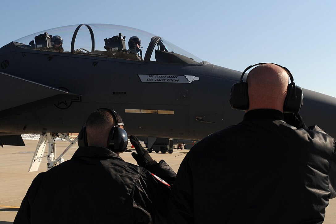 LANGLEY AIR FORCE BASE, Va. -- Staff Sgts. Nate Krueger and Gabe Castillo, F-15E Strike Eagle Demonstration Team crew chiefs, salute Maj. Mike "Cash" Maeder and Capt. Heron "Mach" Weidner, F-15E Strike Eagle Demonstration Team pilots, before takeoff Feb. 3.  The demonstration team flew as part of the Commander Air Combat Command certification flight.  (U.S. Air Force photo/Senior Airman Zachary Wolf)

