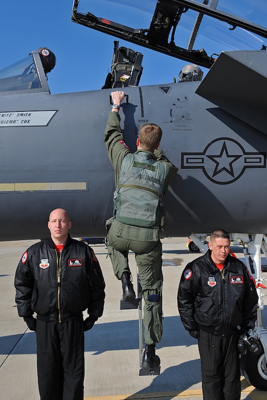 LANGLEY AIR FORCE BASE, Va. -- Maj. Mike "Cash" Maeder, F-15E Strike Eagle Demonstration Team pilot, climbs into the cockpit before takeoff as Staff Sgts. Nate Krueger and Gabe Castillo, F-15E Strike Eagle Demonstration Team crew chiefs, stand at attention Feb. 3.  The demonstration team flew as part of the Commander Air Combat Command certification flight.  (U.S. Air Force photo/Senior Airman Zachary Wolf)
