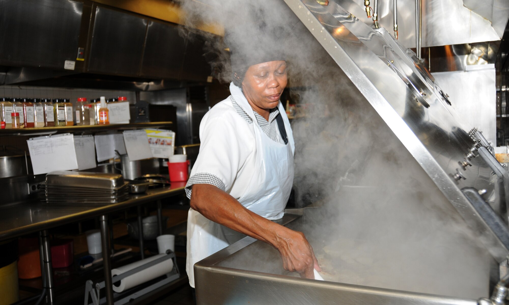Rosetta Thomas grills chicken at the Azalea Dining Facility.  (U.S. Air Force photo by Kemberly Groue)