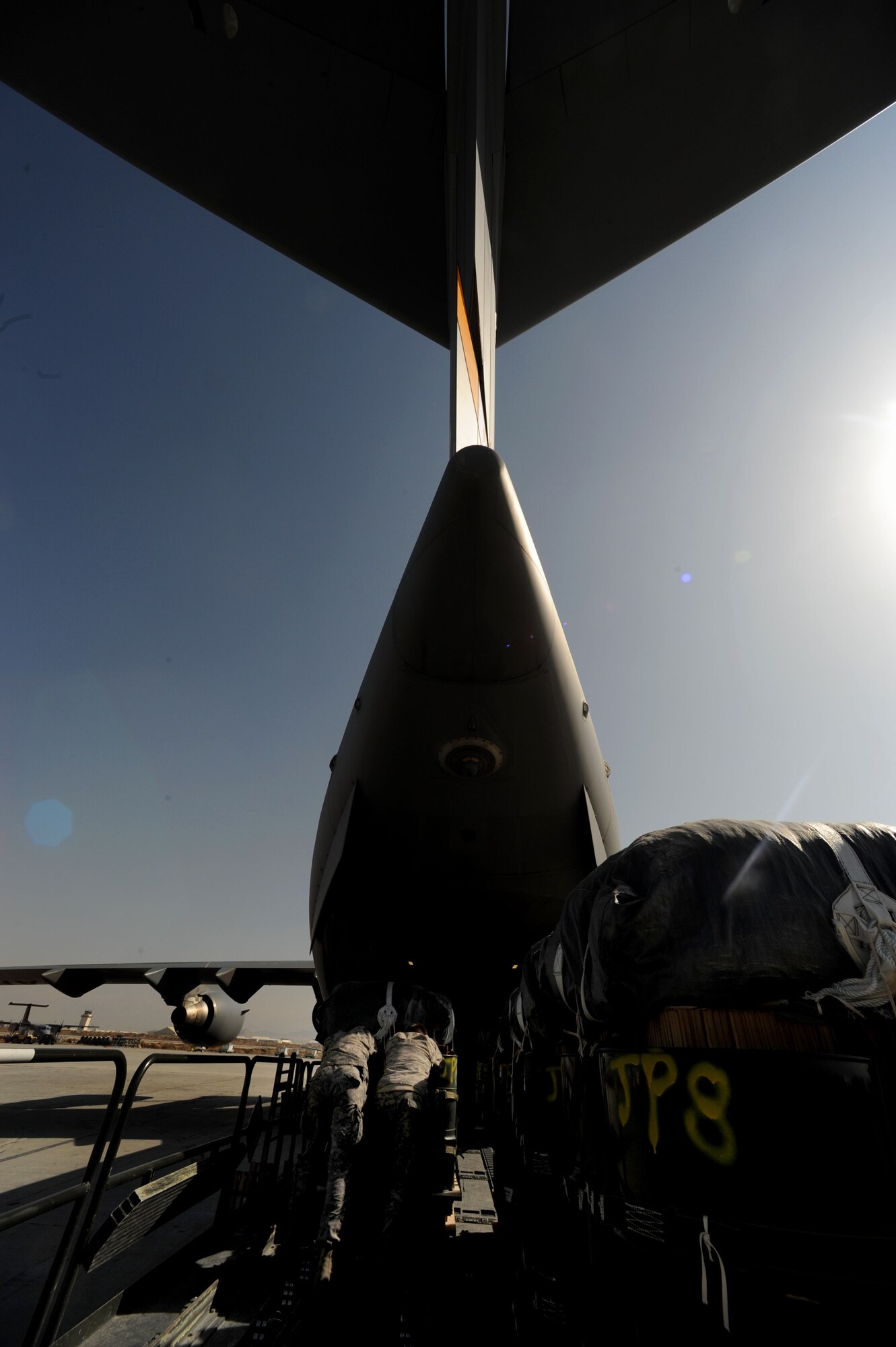 U.S. Army Specialists Richard Thoms and Jason Boyd, parachute riggers from the 612th Quartermaster Detachment, deployed to Bagram Air Base, Afghanistan, from Ft. Bragg, N.C., load a C-17 Globemaster  III with containerized delivery system bundles, Feb. 2,  2010.  The CDS bundles will be air dropped over a foward-operating base in Afghanistan to ground forces in need of supplies.  (U.S. Air Force photo/Staff Sgt. Angelita Lawrence/released)
