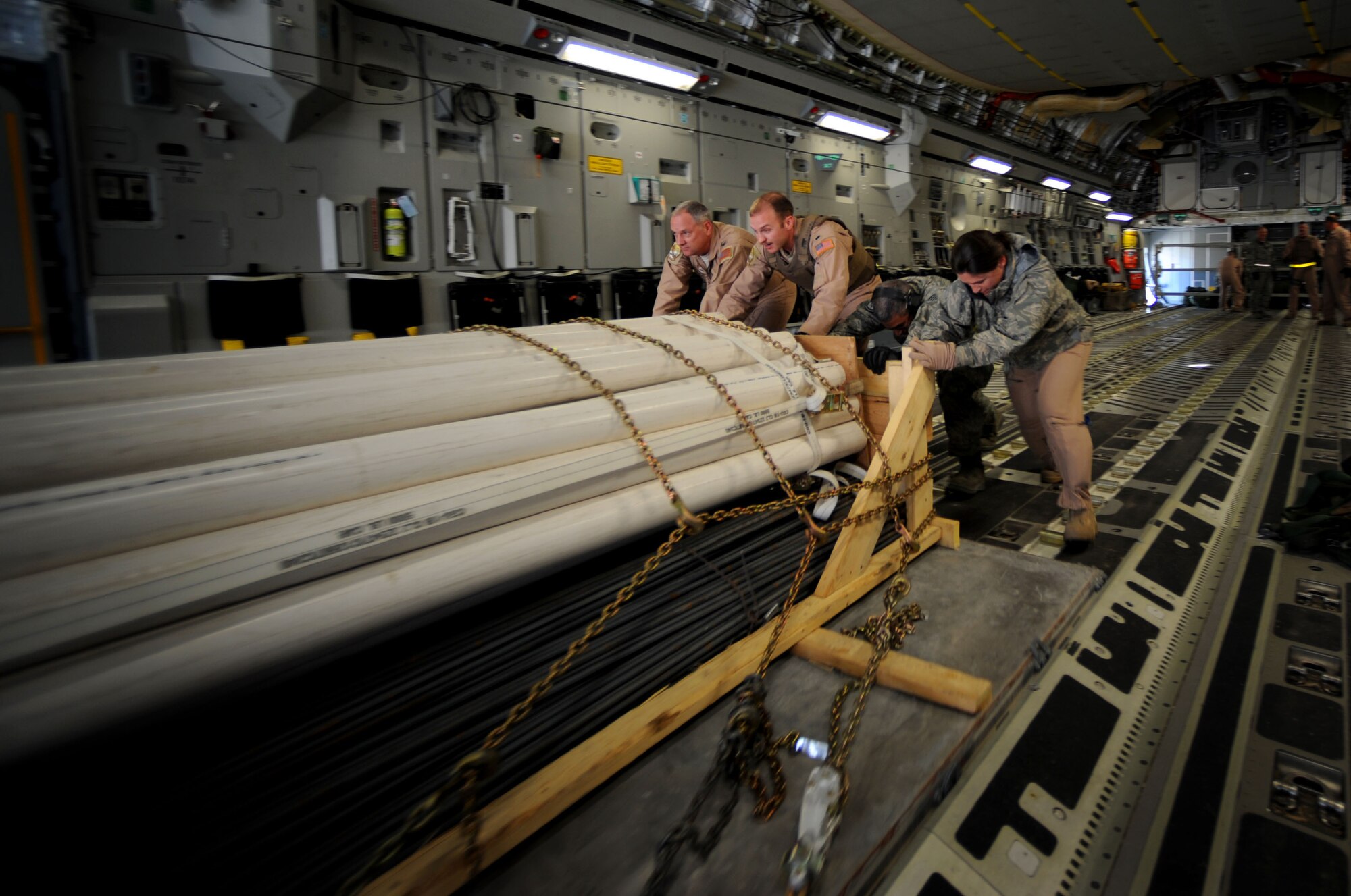 U.S. Air Force Airmen from the 816th Expeditionary Airlift Squadron, unload cargo from a C-17 Globemaster III for an airdrop over Afghanistan Feb. 2, 2010.  The C-17 aircrew will deliver 34 container delivery system bundles over a base in Afghanistan as part of a combat re-supply mission.  (U.S. Air Force photo/Staff Sgt. Angelita Lawrence/released)