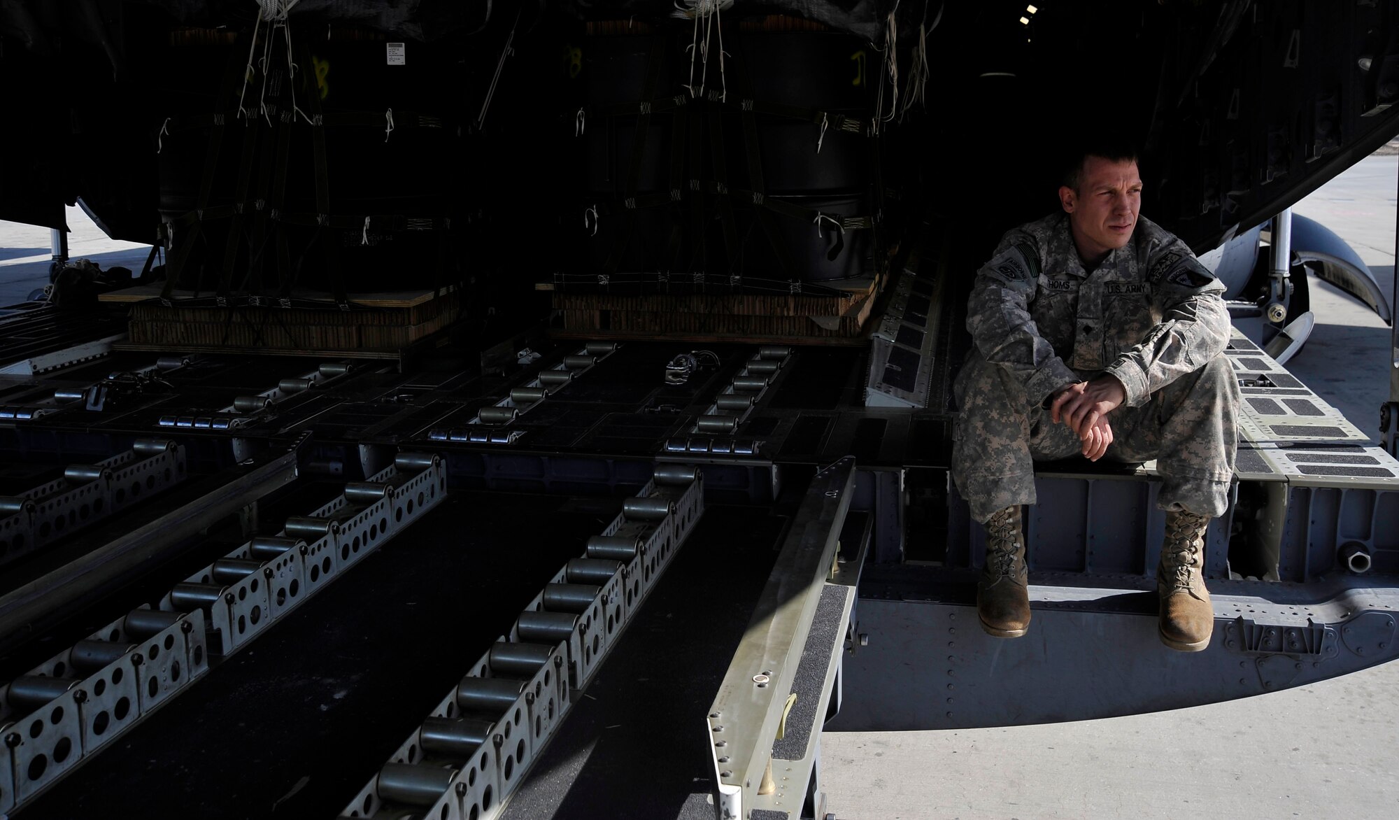 U.S. Army Specialist Richard Thoms, a parachute rigger with the 612th Quartermaster Detachment, from Ft. Bragg, N.C., and deployed to Bagram Air Base, Afghanistan, takes a break after loading and preparing parachutes for an airdrop mission, Feb 2, 2010.  The containerized delivery system bundles will be airdropped from a C-17 Globemaster III to a forward-operating base in Afghanistan.  (U.S. Air Force photo/Staff Sgt. Angelita Lawrence/released)