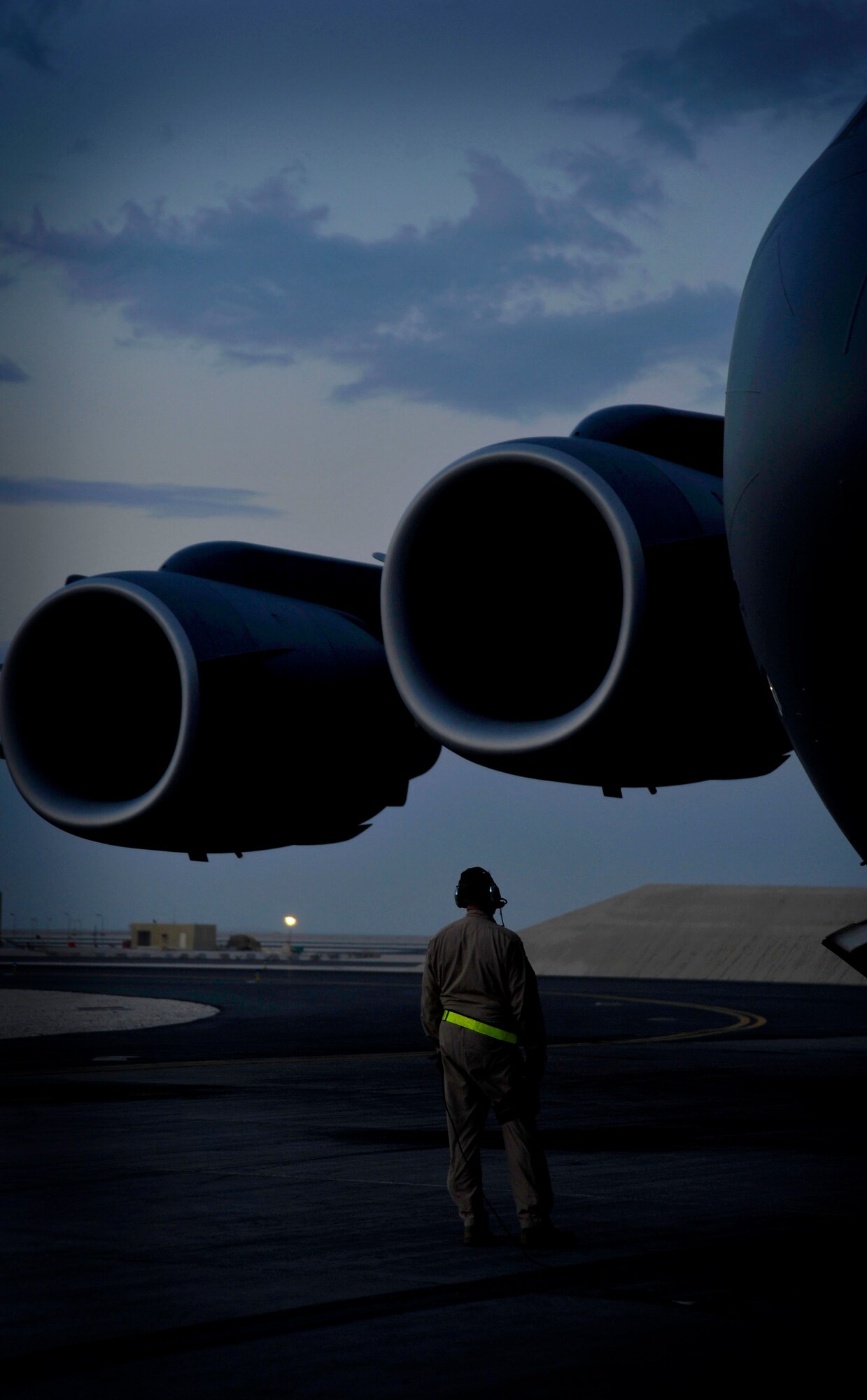 U.S. Air Force Tech. Sgt. Kevin Owen, 816th Expeditionary Airlift Squadron loadmaster, scans the engines on a C-17 Globemaster III during start-up procedures in Southwest Asia before an airdrop mission over Afghanistan, Feb. 2, 2010. The C-17 aircrew will airdrop 34 containerized delivery system bundles to ground forces in need of supplies.  (U.S. Air Force photo/Staff Sgt Angelita Lawrence/released)