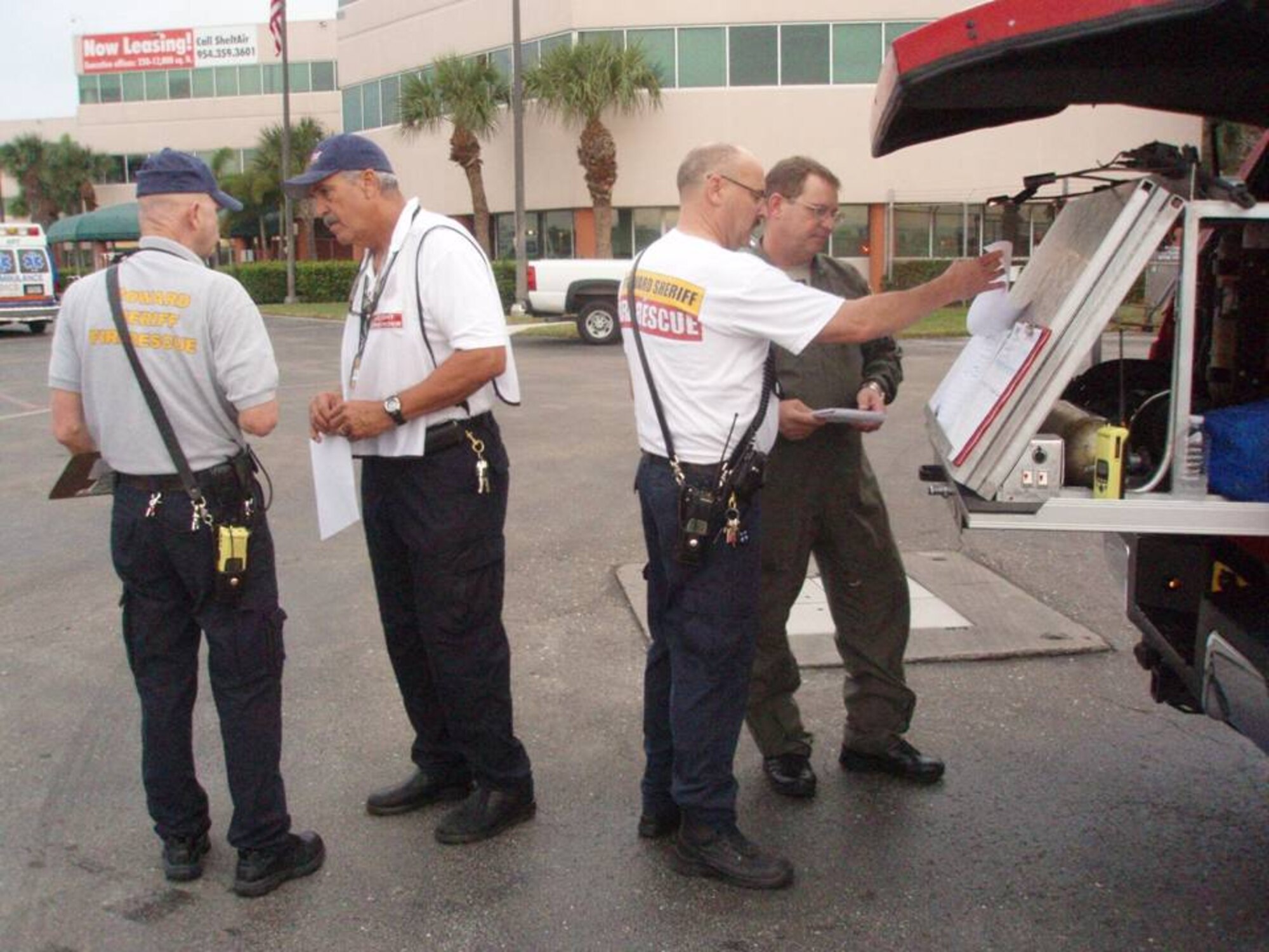 Maj. Chris Reynolds, an Air Forces Northern Emergency Preparedness Liaison Officer, goes over data with a member of Broward County Fire and Rescue at Incident Command Post established at the Ft. Lauderdale International Airport General Aviation Facility on Jan. 23.  EPLOs, trained to respond to natural and manmade disasters in the United States, were on-site to support Haitian earthquake relief efforts. (U.S. Air Force Photo by Lt. Col. Scott Tagg)