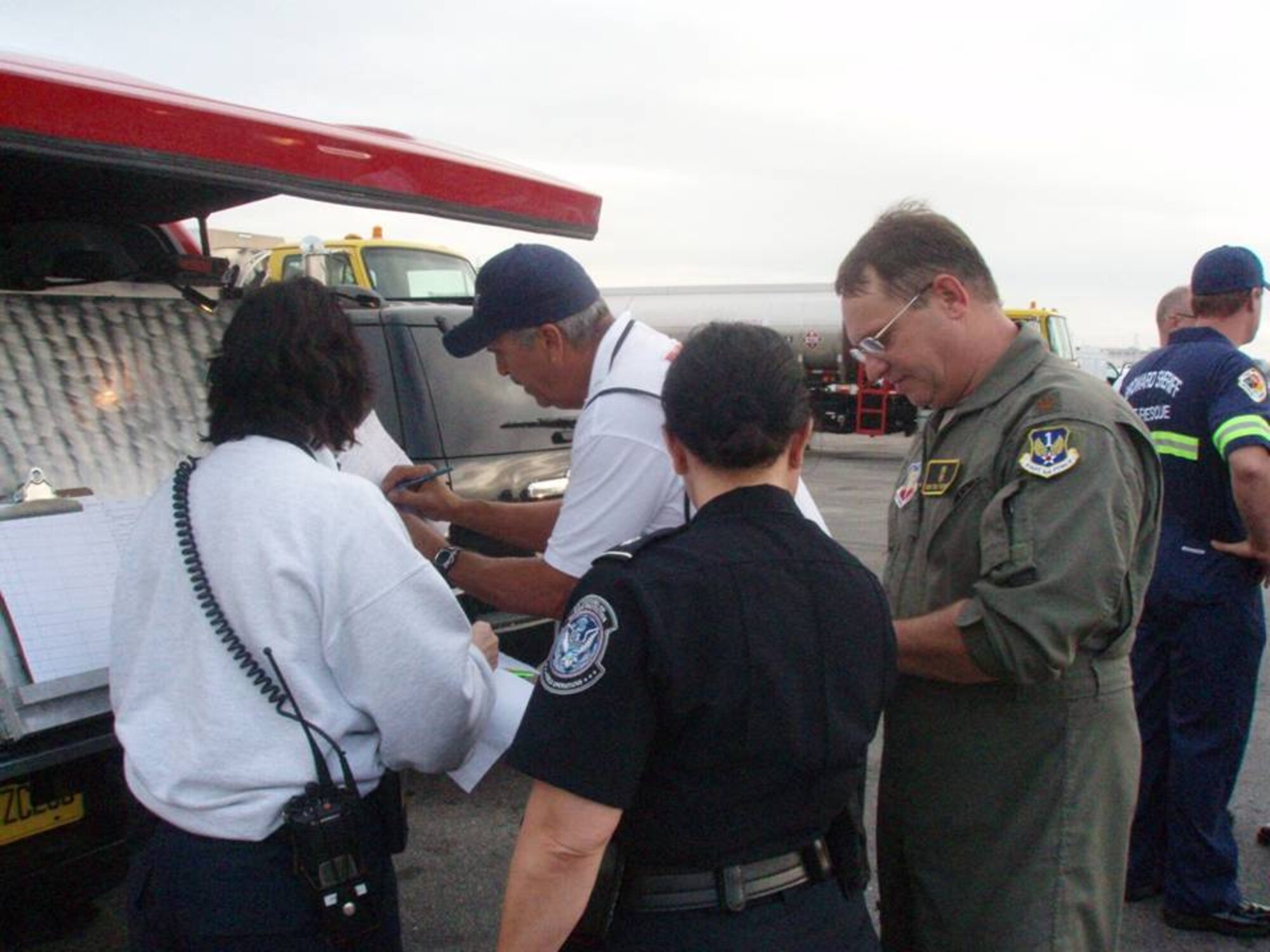 Maj. Chris Reynolds, an Air Forces Northern Emergency Preparedness Liaison Officer, works with Broward County Fire and Rescue and U.S. Customs and Border Patrol officials at Incident Command Post established at the Ft. Lauderdale International Airport General Aviation Facility on Jan. 23.  EPLOs, trained to respond to natural and manmade disasters in the United States, were on-site to support Haitian earthquake relief efforts. (U.S. Air Force Photo by Lt. Col. Scott Tagg)