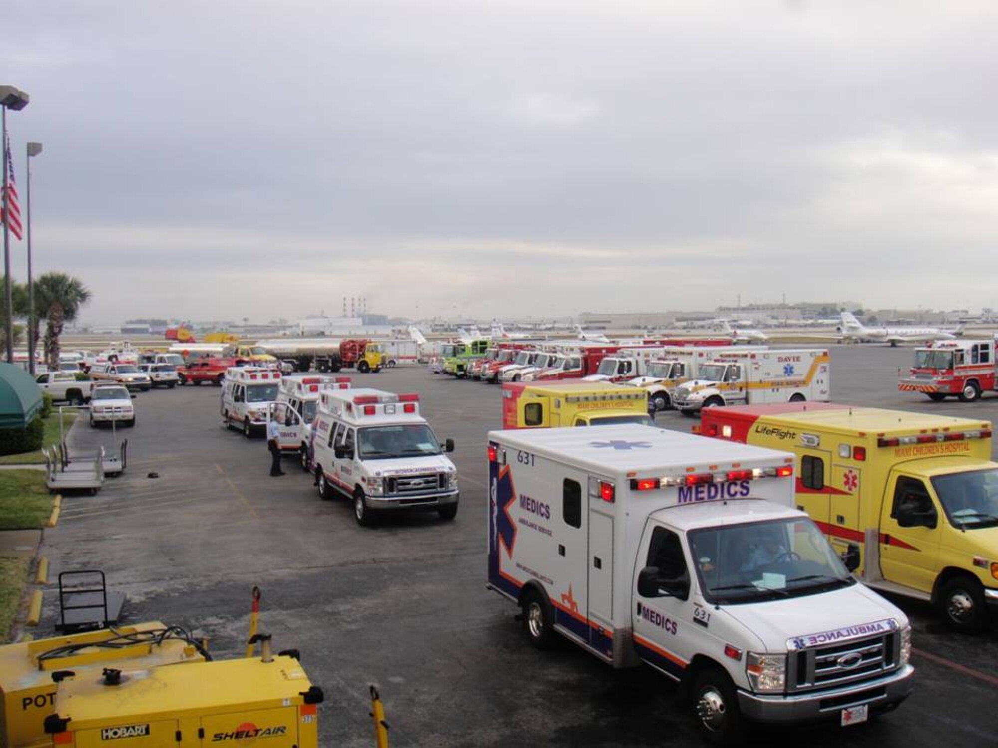 Ambulances are awaiting the arrival of U.S. Air Force C-130 Hercules transports carrying Haitian evacuees to the Ft. Lauderdale International Airport General Aviation Facility on Jan. 23. Air Forces Northern Emergency Preparedness Liaison Officers, trained to respond to natural and manmade disasters in the United States, were on-site to support Haitian earthquake relief efforts.(U.S. Air Force Photo by Lt. Col. Scott Tagg