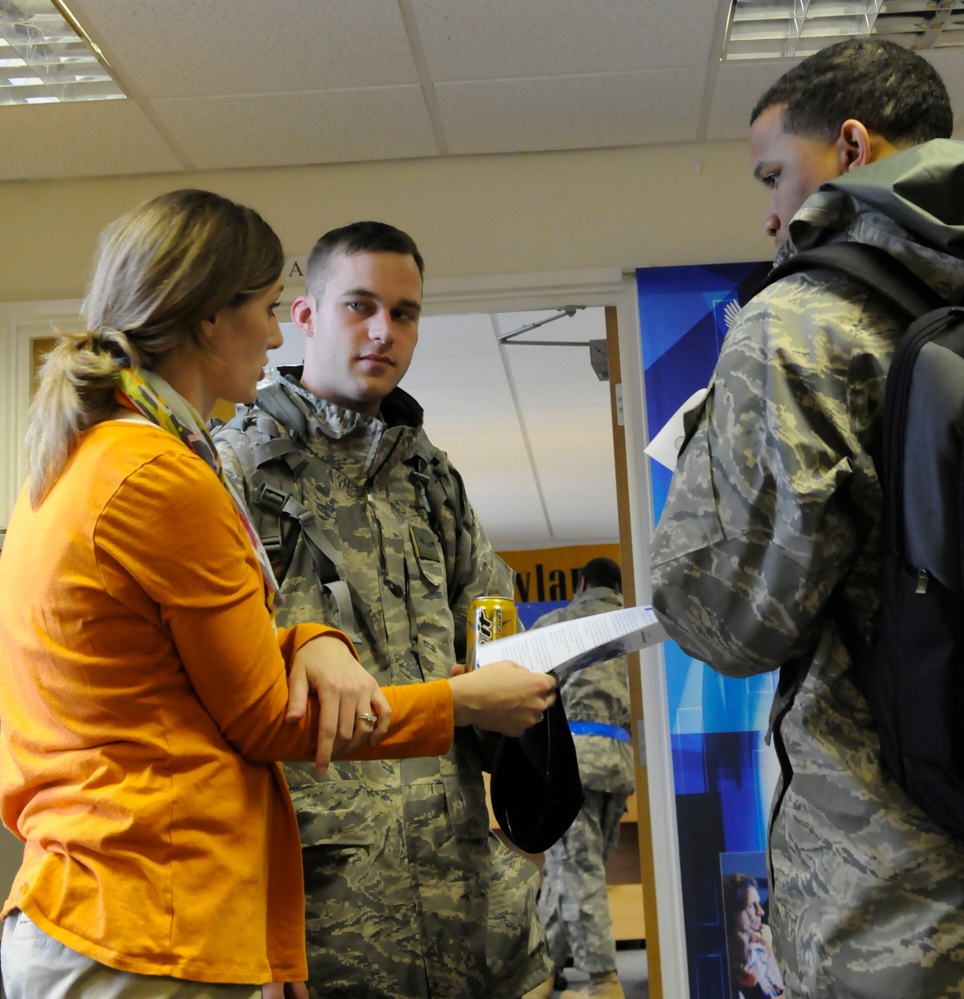 RAF MILDENHALL, England -- Sarina Houston, a school representative at the education office, talks to Airmen 1st Class Kyle Beagle (left) and Brandon Burress, 100th Security Forces Squadron, about their education options while stationed at RAF Mildenhall.  The education office hosts five schools and also advises students on its various programs.  (U.S. Air Force photo/Staff Sgt. Christopher L. Ingersoll)
