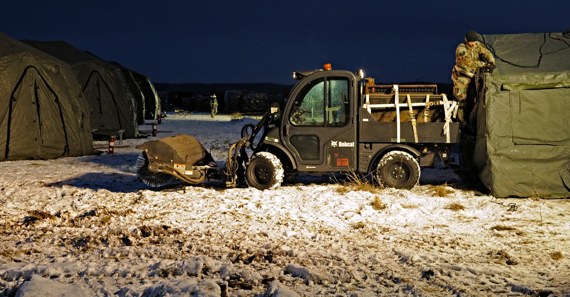 FLUGPLATZ BITBURG, Germany – Tech. Sgt. Kevin Welch, 435th Air Mobility Squadron, Ramstein Air Base, Germany, works into the night setting up tents on the flightline of Flugplatz Bitburg during an operational readiness exercise Jan. 27. Members from Ramstein’s 435th Air Ground Operations Wing and the 86th Airlift Wing worked together to set up bare-base operations at Flugplatz Bitburg. This was the second of five OREs Ramstein is performing to prepare for an inspection in September. (U.S. Air Force photo/Senior Airman Benjamin Wilson)