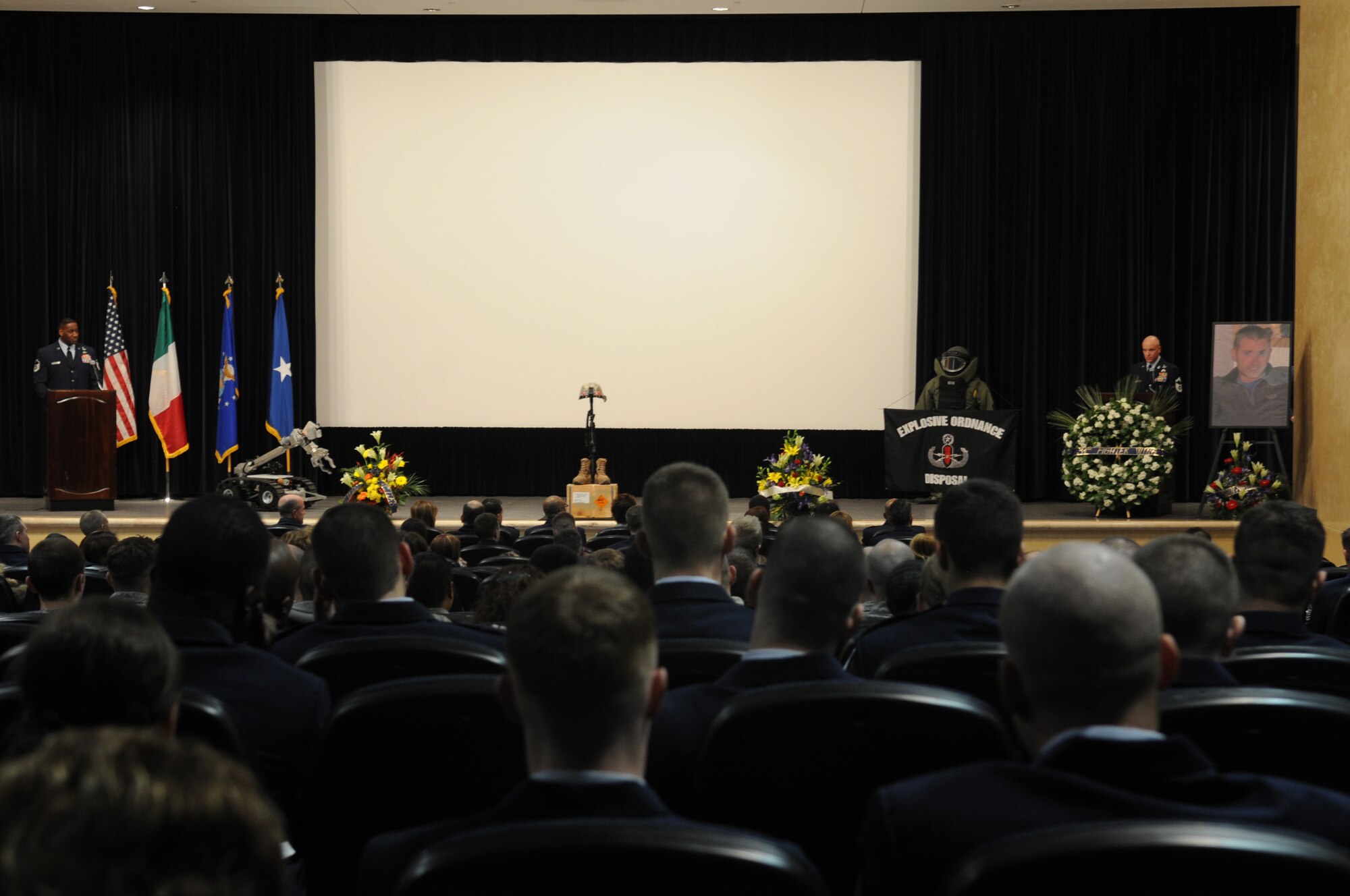 Military and civilian members of the 31st Fighter Wing pay their respects to Tech. Sgt. Adam K. Ginett during a memorial service at Aviano Air Base, Italy held Feb. 1, 2010. Sergeant Ginett, a Knightdale, N.C. native, died Jan. 19 near Kandahar Air Field, Afghanistan, of wounds suffered from an improvised explosive device. He was assigned to the 31st Civil Engineer Squadron explosive ordnance disposal flight, Aviano AB, Italy.