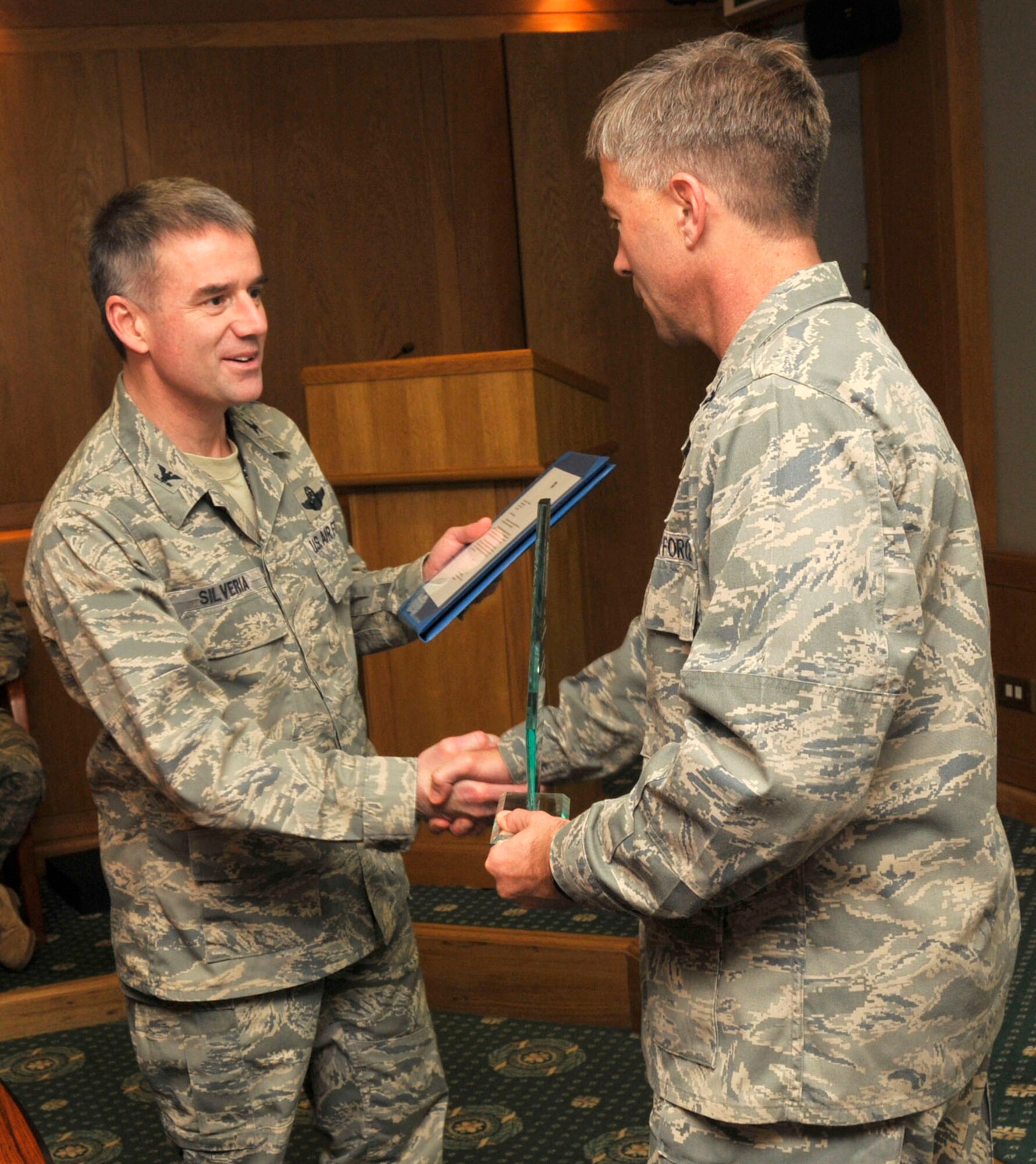 Col. Jay Silveria, 48th Fighter Wing commander, presents the Air Force’s 2009 Hospital of the Year trophy to Col. Kenneth McDonnell, 48th MDG commander, Feb. 2. RAF Lakenheath’s hospital placed first out of 72 competing against other Air Force medical treatment facilities from across the globe, first winning at United States Air Forces in Europe level, before winning at Air Force level. (U.S. Air Force photo by Airman 1st Class Eboni Knox)