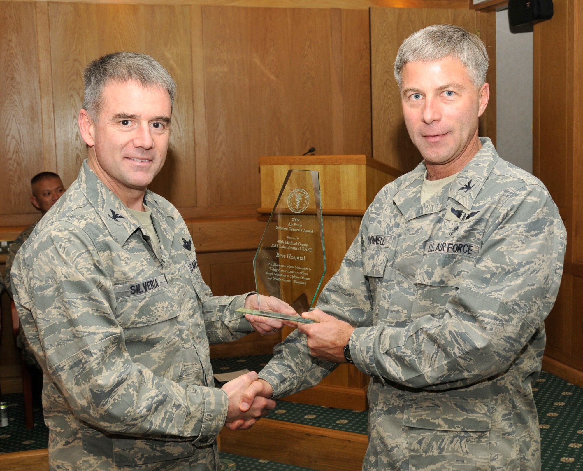 Col. Jay Silveria, 48th Fighter Wing commander, presents the Air Force’s 2009 Hospital of the Year trophy to Col. Kenneth McDonnell, 48th MDG commander, Feb. 2. RAF Lakenheath’s hospital placed first out of 72 competing against other Air Force medical treatment facilities from across the globe, first winning at United States Air Forces in Europe level, before winning at Air Force level. (U.S. Air Force photo by Airman 1st Class Eboni Knox)