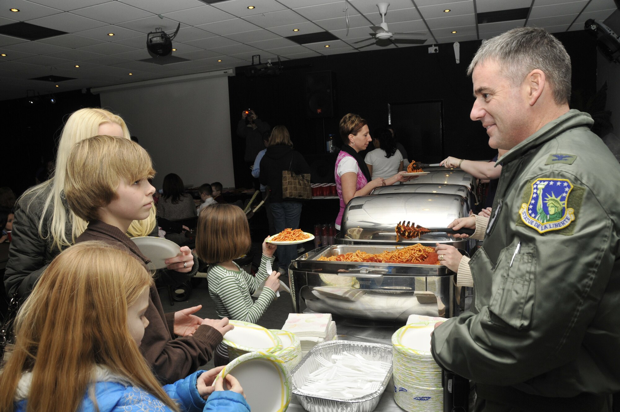 Col. Jay Silveria, 48th Fighter Wing commander, greets families of deployed military members during the second deployed spouses dinner of the year at the 48th Community Center on RAF Lakenheath, England. The event provides an opportunity for deployed spouses to gather and talk with others in a similar situation. (U.S. Air Force photo/Airman 1st Class Eboni Knox)