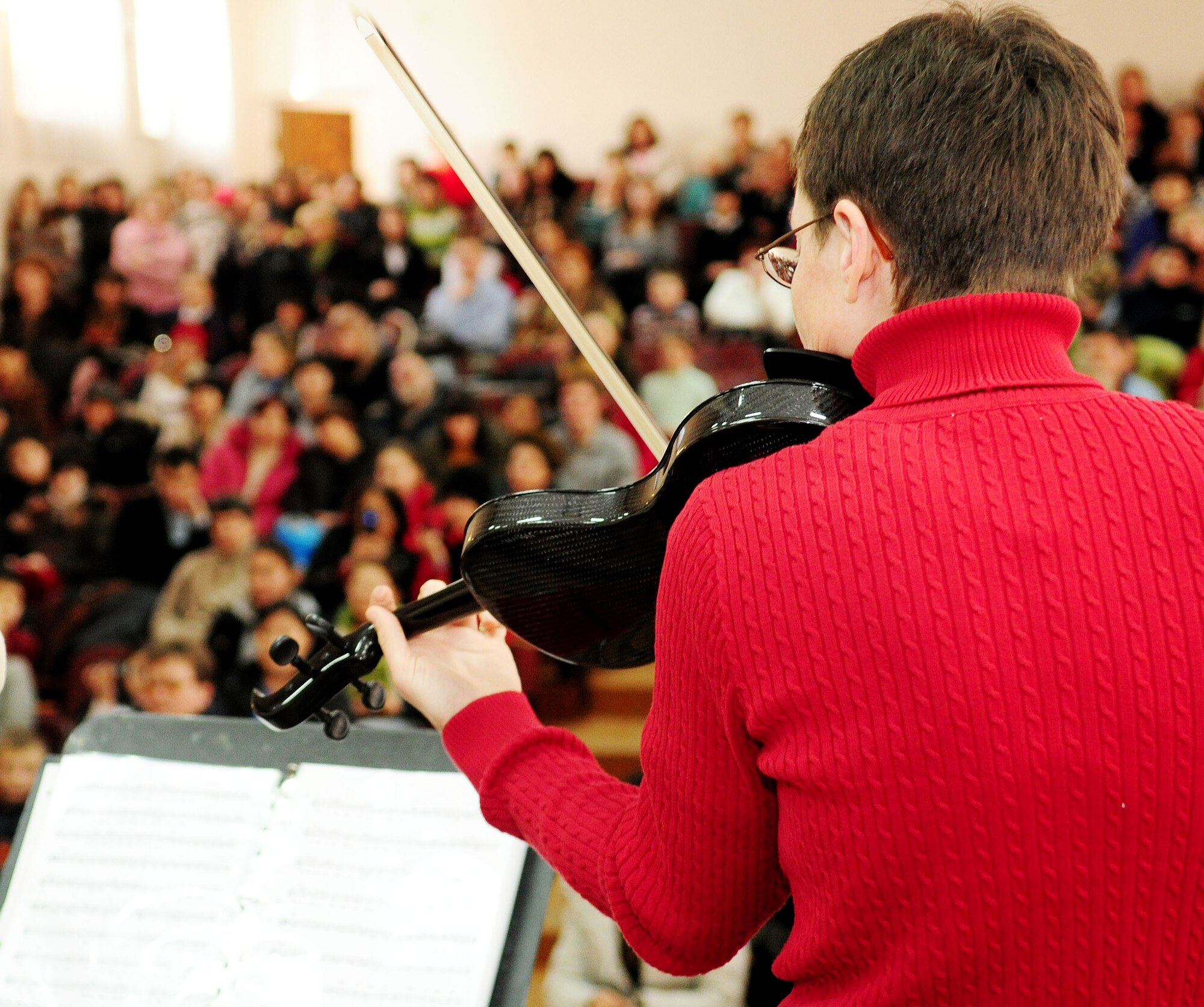 U.S. Air Force Senior Master Sgt. Deborah Volker plays in front of a packed crowd of young musicians, teachers and others during a performance at the Shubin Music School in Bishkek, Kyrgyzstan, Feb. 1, 2010. Senior Master Sgt. Volker is violinist and NCOIC of "Celtic Aire," the U.S. Air Forces Central Public Affairs band. (U.S. Air Force photo/Senior Airman Nichelle Anderson/released)
