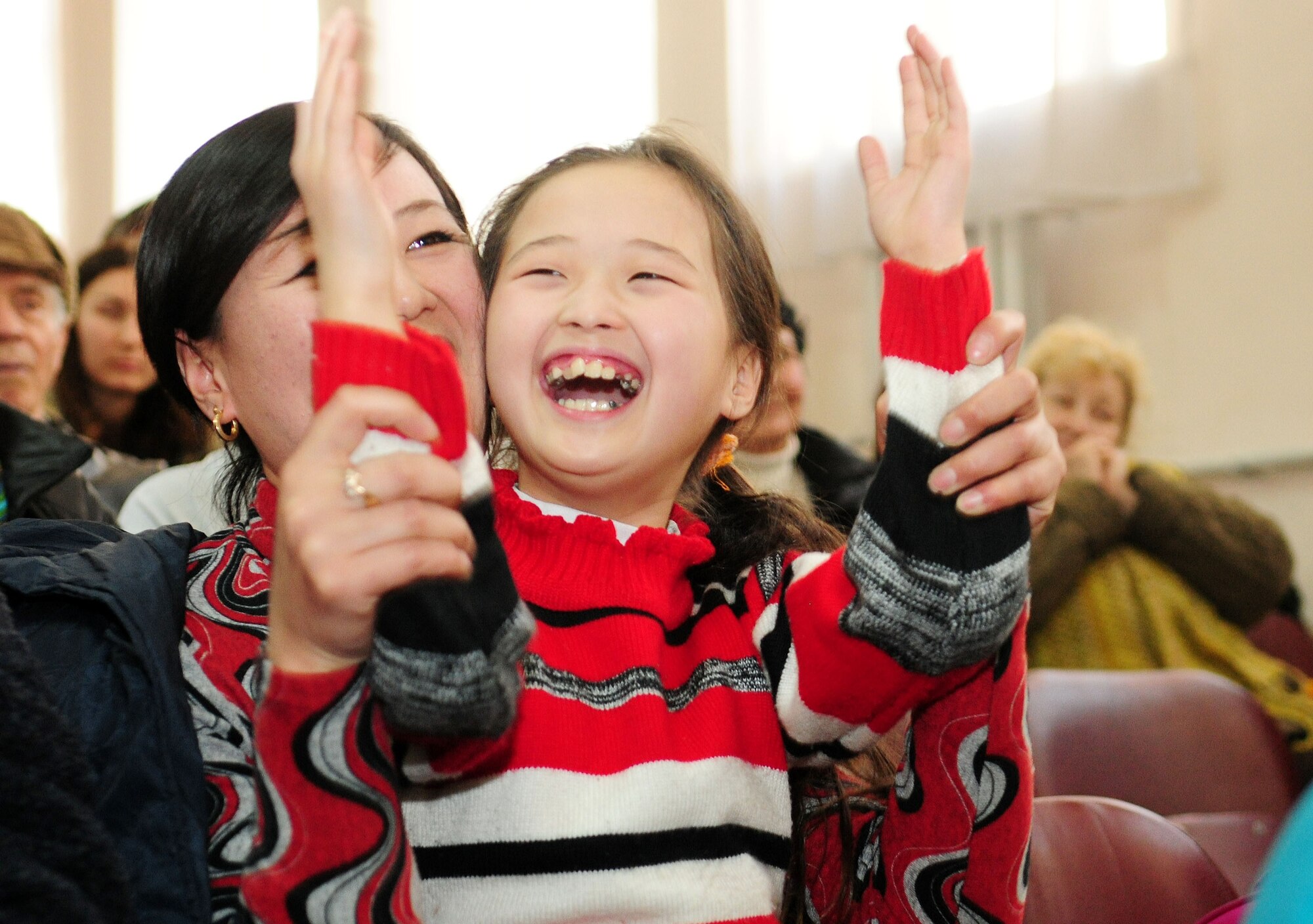 Audience members clap after a performance at the Shubin Music School in Bishkek, Kyrgyzstan, Feb. 1, 2010 by "Celtic Aire," the U.S. Air Forces Central Public Affairs band.  (U.S. Air Force photo/Senior Airman Nichelle Anderson/released)
