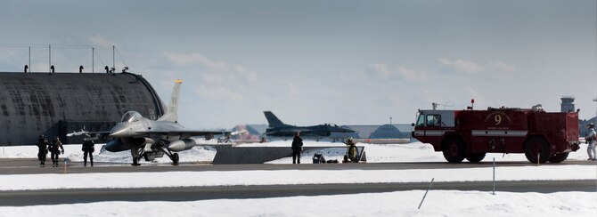 MISAWA AIR BASE, Japan -- A 35th Civil Engineer Squadron fire truck arrives at the scene of a simulated in-flight emergency on the flightline during an operational readiness exercise Feb. 2. Crewchiefs, firemen and weapons systems maintainers practiced responding to a jammed 20-millimeter gun. (U.S. Air Force photo/Staff Sgt. Samuel Morse)