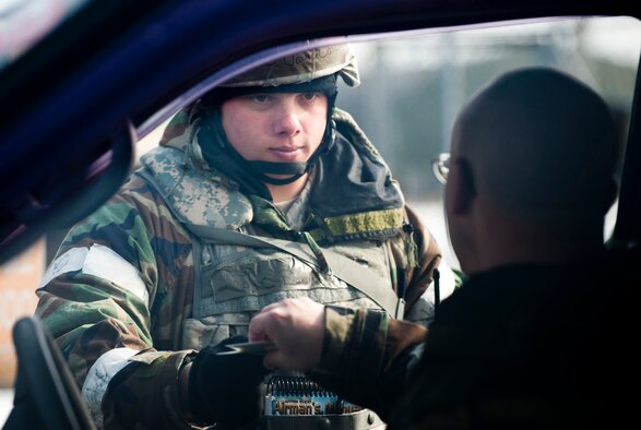 MISAWA AIR BASE, Japan -- Airman 1st Class David Cook, 35th Security Forces Squadron entry controller, hands back a flightline authorization badge after checking it at an entry control point during an operational readiness exercise Feb. 2. Entry controllers are responsible for making sure that people entering the flightline are authorized to be there and that their badges are authentic. (U.S. Air Force photo/Staff Sgt. Samuel Morse)