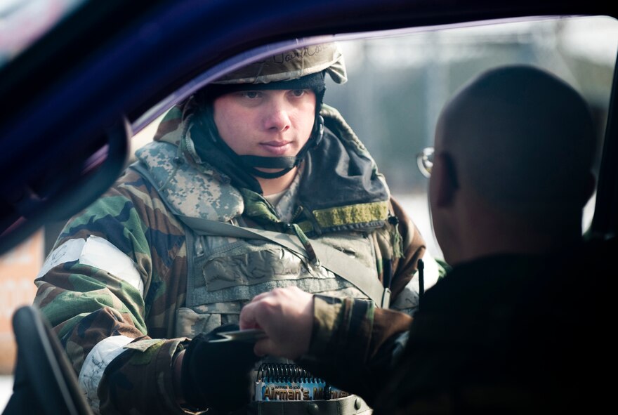 MISAWA AIR BASE, Japan -- Airman 1st Class David Cook, 35th Security Forces Squadron entry controller, hands back a flightline authorization badge after checking it at an entry control point during an operational readiness exercise Feb. 2. Entry controllers are responsible for making sure that people entering the flightline are authorized to be there and that their badges are authentic. (U.S. Air Force photo/Staff Sgt. Samuel Morse)