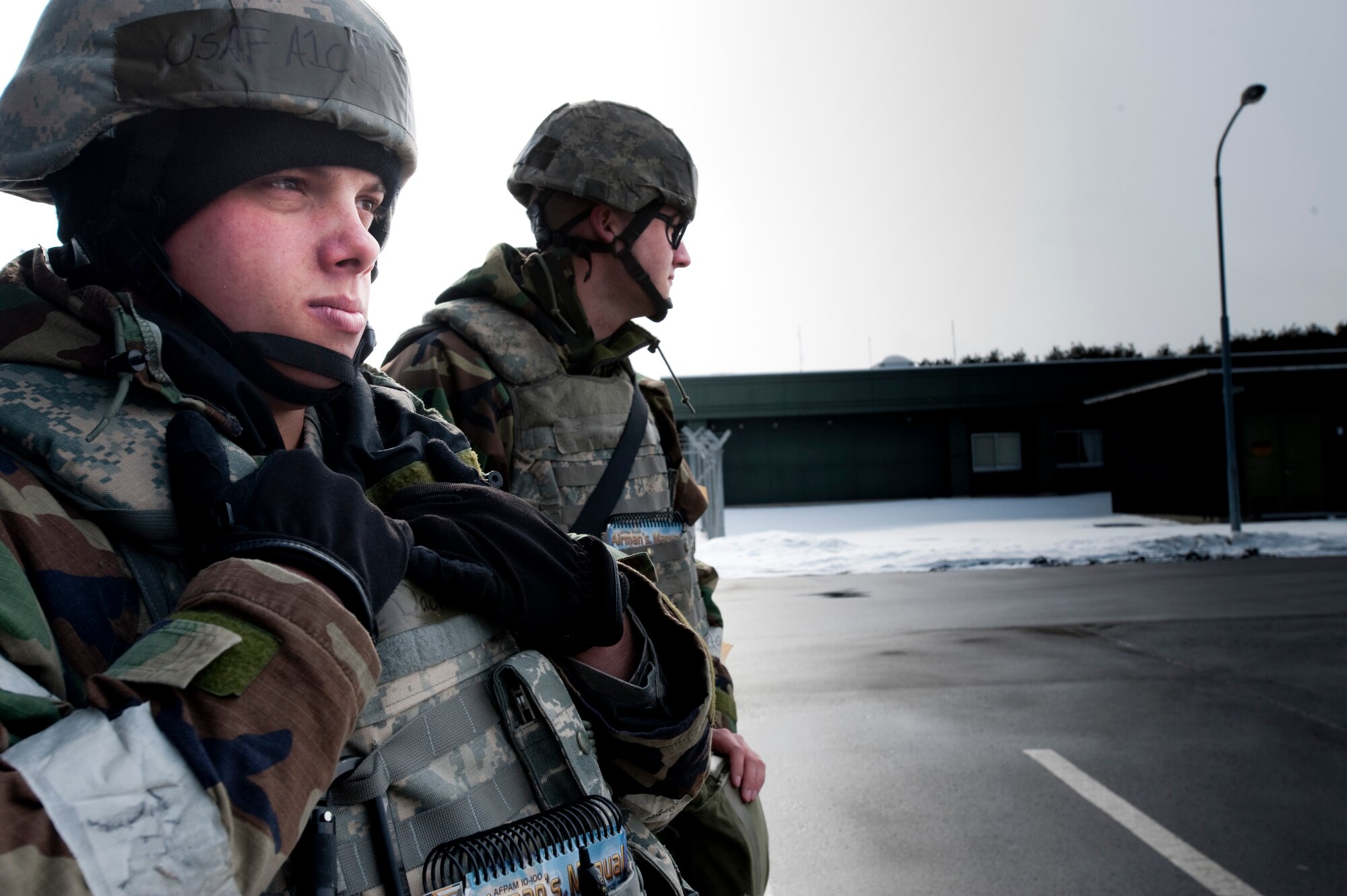 MISAWA AIR BASE, Japan -- Airmen 1st Class David Cook and Benjamin Baird, 35th Security Forces entry controllers, stand guard at a flightline entry control point during an operational readiness exercise Feb. 2. This exercise gave security forces Airmen a chance to practice their security techniques at their home station prior to deploying. (U.S. Air Force photo/Staff Sgt. Samuel Morse)