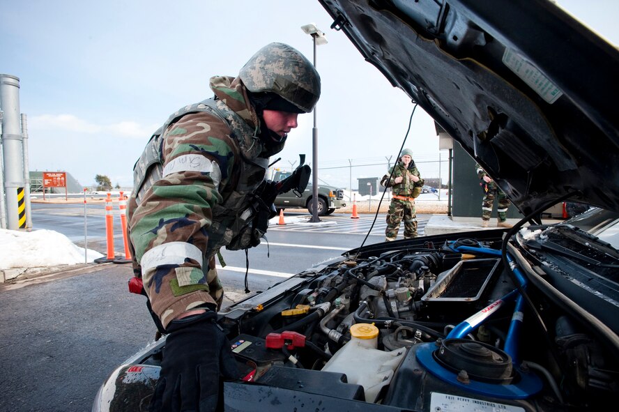 MISAWA AIR BASE, Japan -- Airman 1st Class David Cook, 35th Security Forces Squadron entry controller, inspects a vehicle at a flightline control point during an operational readiness exercise Feb. 2. Airman Cook performed random vehicle inspections to maintain a high level of force protection on the flightline. (U.S. Air Force photo/Staff Sgt. Samuel Morse)