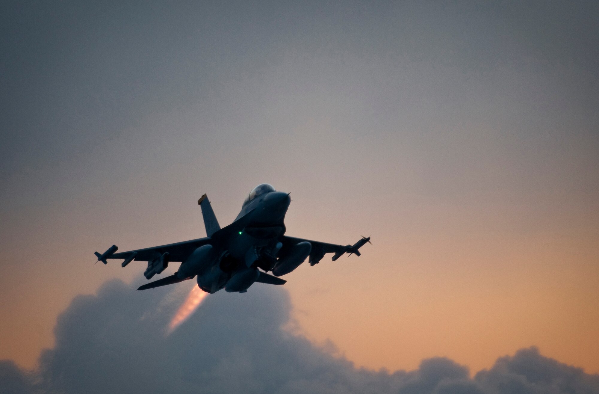 MISAWA AIR BASE, Japan -- Capt. Cory Farrer, 13th Fighter Squadron pilot, takes off in an F-16 Fighting Falcon just before dawn Feb. 3. Since Sept. 11, 2001, the F-16 has been a major component of combat forces flying thousands of sorties in support of Operations Noble Eagle, Enduring Freedom and Iraqi Freedom. (U.S. Air Force photo/Staff Sgt. Samuel Morse)