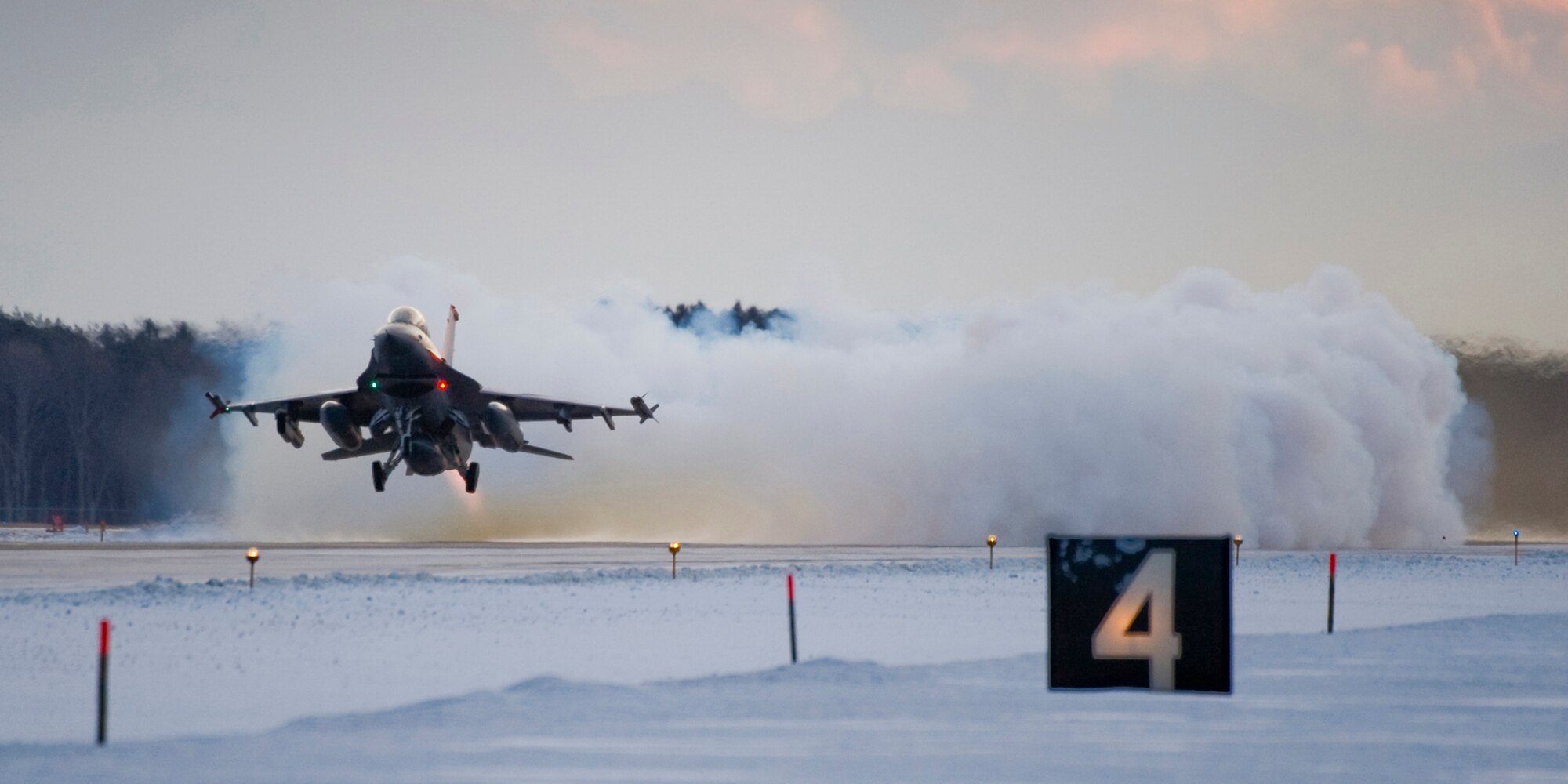 MISAWA AIR BASE, Japan -- While piloting an F-16 Fighting Falcon, Capt. Craig Phelps takes off into the Misawa morning sky Feb. 3 during Exercise Beverly Sunrise 10-01. Lasting a total of eight days, the exercise's aim was to hone Airmen's skills as they operated in a "deployed" environment. (U.S. Air Force photo/Senior Airman Jamal D. Sutter)