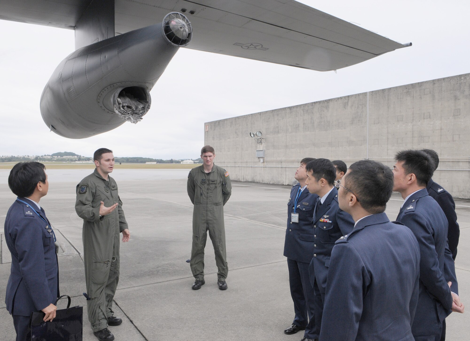 KADENA AIR BASE Japan -- Senior Airman Joshua Baker, a flight engineer with the 17th Special Operations Squadron, discusses the characteristics and operations of the refueling pod on an MC-130P Combat Shadow to officers from the Japan Air Self Defense Force here Feb. 3. The JASDF officers visited the 353rd Special Operations Group as part of a bilateral exchange program between the United States and Japan. (U.S. Air Force photo by Tech. Sgt. Aaron Cram)