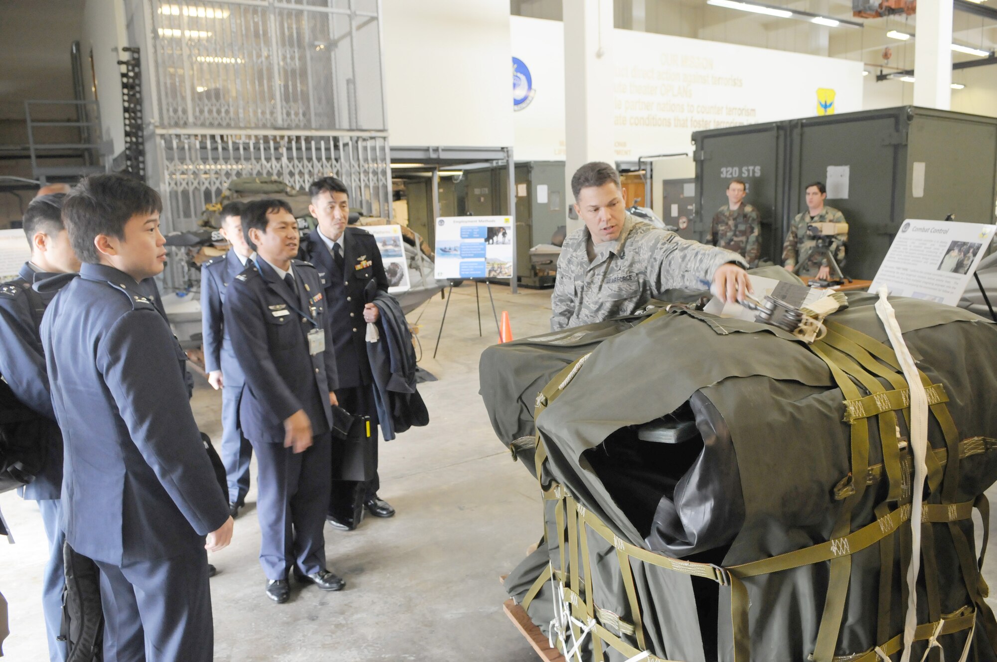 KADENA AIR BASE Japan -- Senior Master Sgt. James Remington, a combat controller with the 320th Special Tactics Squadron, shows officers from the Japan Air Self Defense Force a Riggable Alternate Method Zodiac package during their visit here Feb. 3. The JASDF officers visited the 353rd Special Operations Group as part of a bilateral exchange program between the United States and Japan. (U.S. Air Force photo by Tech. Sgt. Aaron Cram)