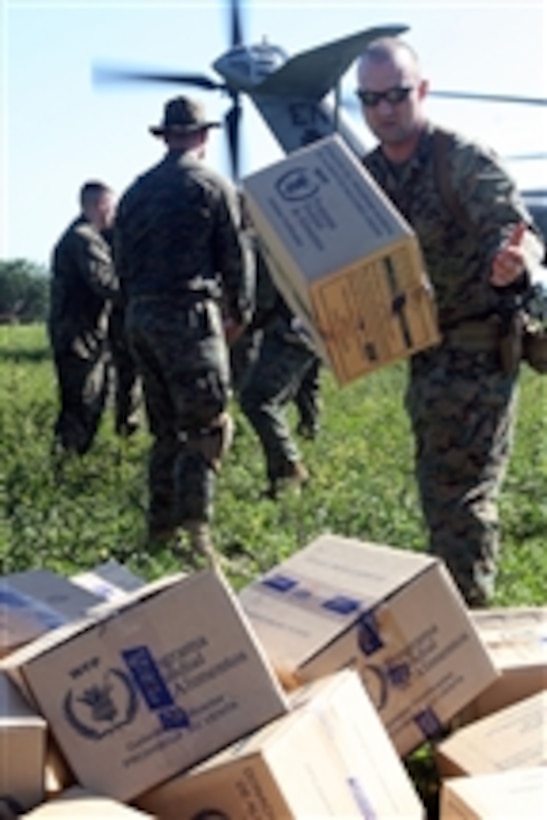 U.S. Marines from Weapons Company, Battalion Landing Team, 3rd Battalion, 2nd Marine Regiment, 22nd Marine Expeditionary Unit unload a CH-53E Super Stallion helicopter from Marine Heavy Helicopter Squadron 461 in Cotes De Fer, Haiti, on Jan 21, 2010.  Marines and sailors from the 22nd Marine Expeditionary Unit set up a temporary relief supply distribution point near Cotes de Fer.  They brought in bottled water and food for internally displaced Haitians.  The 22nd Marine Expeditionary Unit, embarked aboard the ships of the USS Bataan (LHD 5) Amphibious Ready Mission, is deployed in support of relief operations in Haiti.  