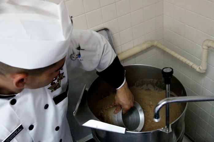 Lance Cpl. Jesus Hernandez, a Northside food service specialist, stirs the bean pilaf he plans to use to win the 2nd Quarter Fiscal Year 2010 Chef of the Quarter competition at the Southside Mess Hall here Feb. 4. Hernandez said he had to figure out how to modify the recipe he learned from his mother to use the ingredients available to him in Japan.