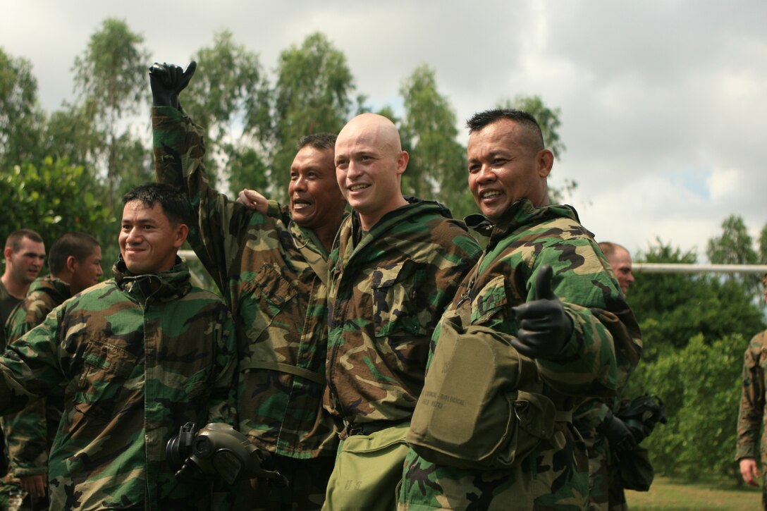 Marines with Combat Logistic Battalion 31 (CLB-31), 31st Marine Expeditionary Unit (MEU), and Royal Thai Air Force service members congratulate each other after a race in Mission Oriented Protective Posture (MOPP) level four gear, Feb. 5. The MEU is currently participating in exercise Cobra Gold 2010 (CG’ 10). The exercise is the latest in a continuing series of exercises design to promote regional peace and security. (Official Marine Corps photo by Lance Cpl. Dengrier M. Baez)
