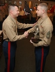 GySgt. Joshua Shaffer, SNCOIC or RSS Kokomo, is presented with the Centurion trophy after having the title bestowed upon him.  Shaffer enlisted 100 qualified young men and women, 80 percent in the upper mental groups and all them were Tier 1, High School Graduates.