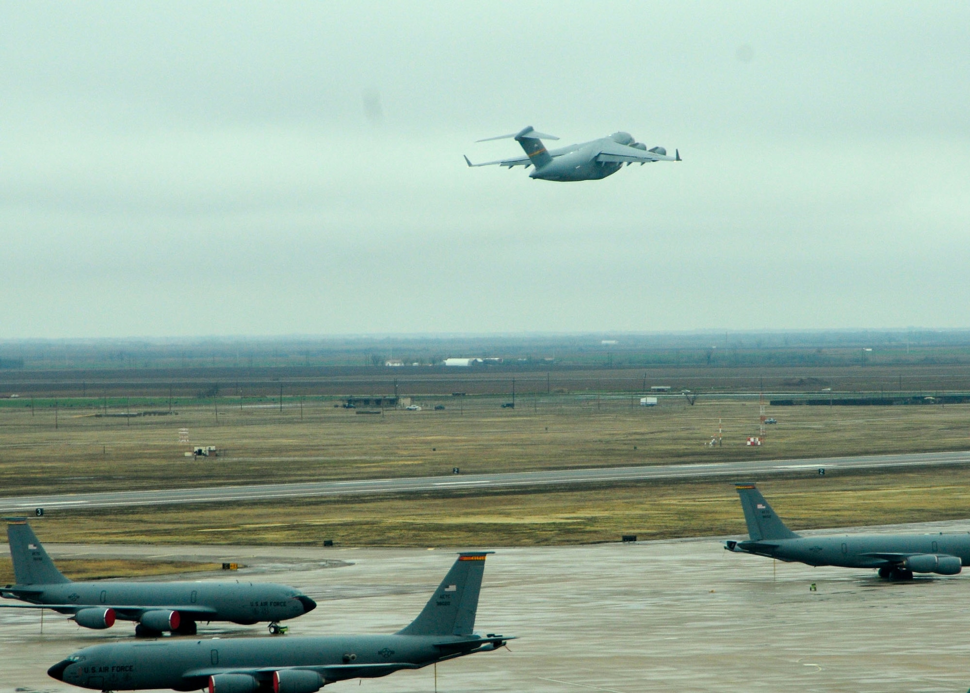 ALTUS AIR FORCE BASE, Okla. -- A C-17 Globemaster III takes off from Altus AFB Feb. 4. The C-17 is relocating to Kelly AFB to temporarily continue flight training for the aircrews to the severe ice storm that swept through the area Jan. 28. Three C-17s and three KC-135s along with 67 personnel – aircrew and maintenance – went to Kelly AFB for training.  (U.S. Air Force photo/ Airman 1st Class Myles T. Stepp)