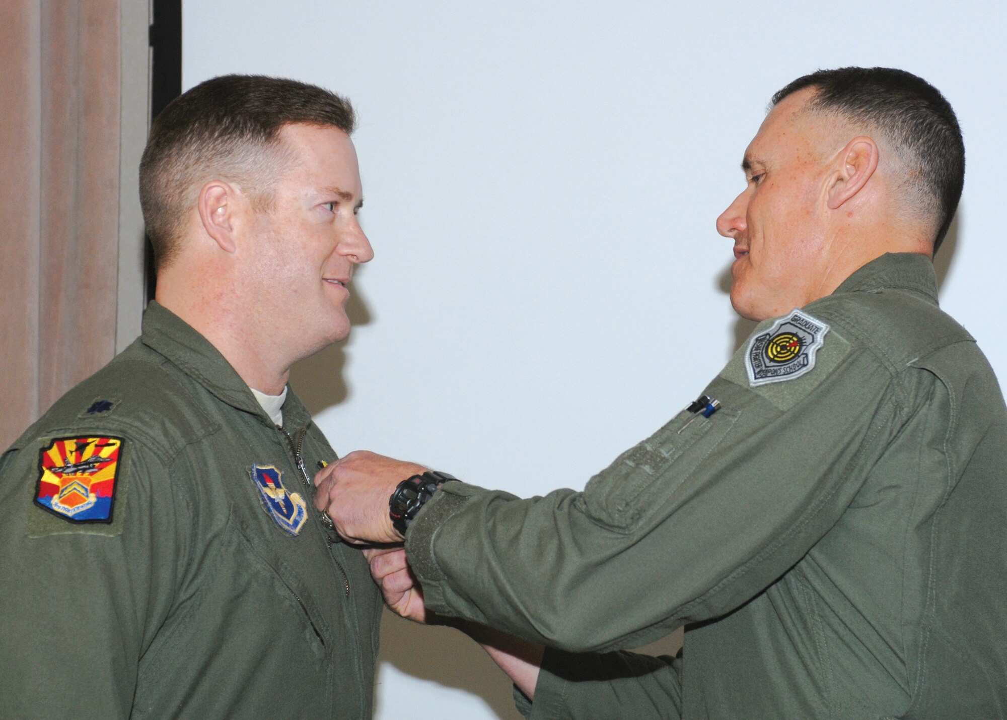 Brig. Gen. Kurt Neubauer, 56th Fighter Wing commander, pins the Bronze Star on Lt. Col. Kip Wilkowski, 56th FW Exercises and Evaluation chief, during a commander's call Jan. 8.
