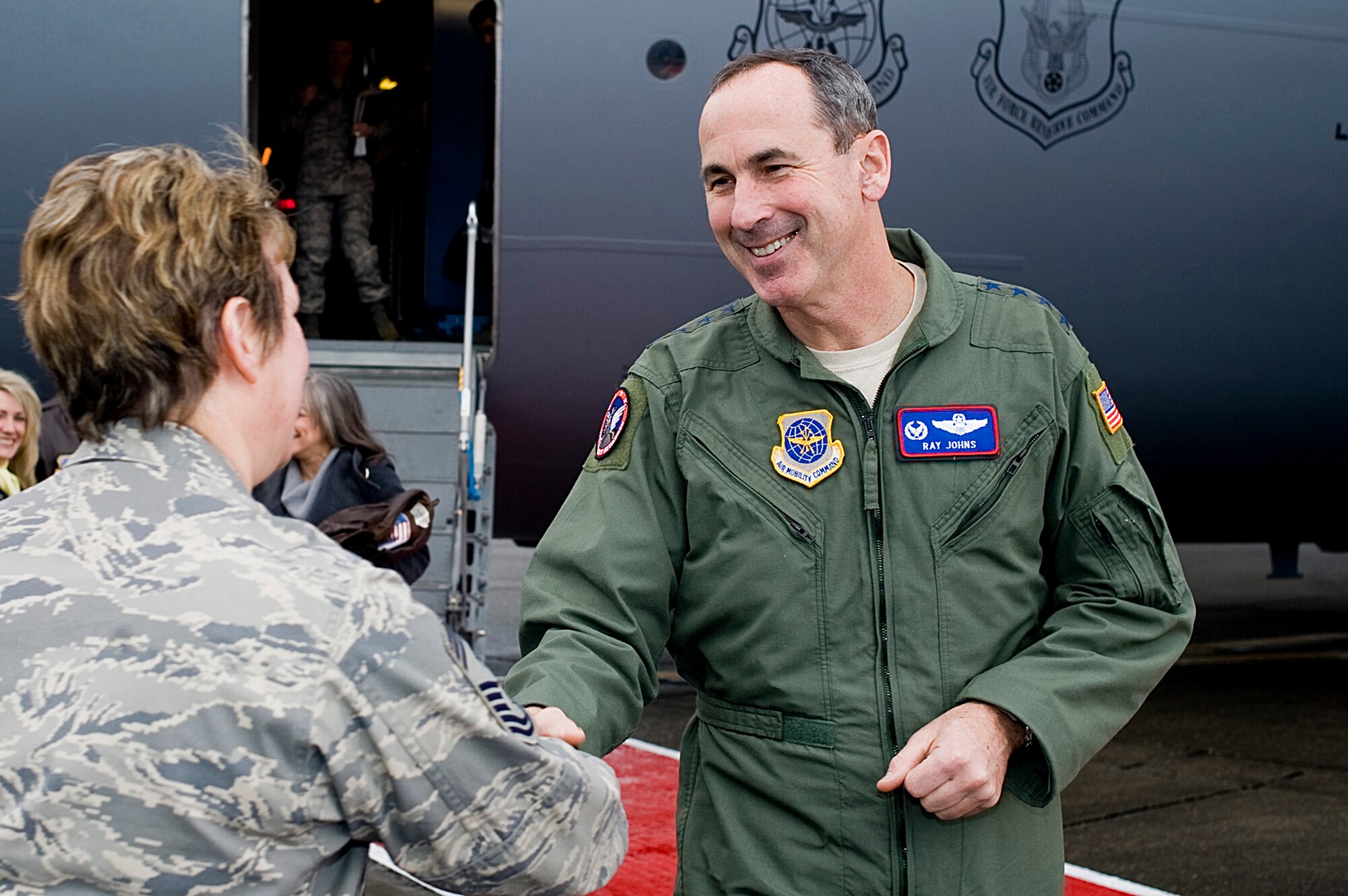 Gen. Raymond Johns, Jr., Air Mobility Command commander, right, greets Chief Master Sgt. Gloria Bennett, 446th Airlift Wing command chief, while visiting McChord Air Force Base, Wash., the last week of January. Gen Johns attended a joint basing briefing, and met with 446th AW Reserve Airmen and civilians, during his visit. (U.S. Air Force photo/Abner Guzman)