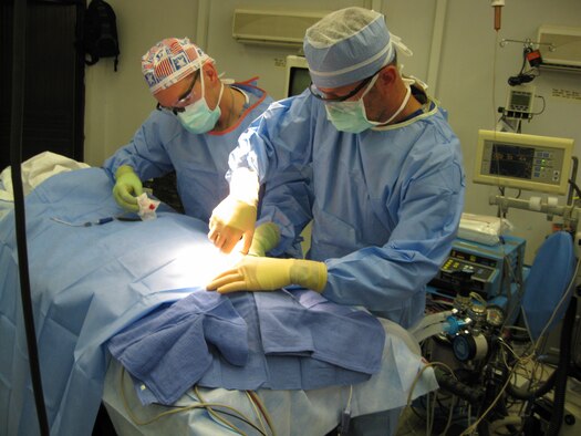 Capt. Jason Rogers, right, and Maj. Jeff Lewis, left, perform a surgical operation in Afghanistan July 3, 2009. Captain Rogers, a physician assistant with the 10th Medical Group, received a Bronze Star Medal during a 10th Air Base Wing commander?s call Jan. 26, 2010. (U.S. Air Force photo)