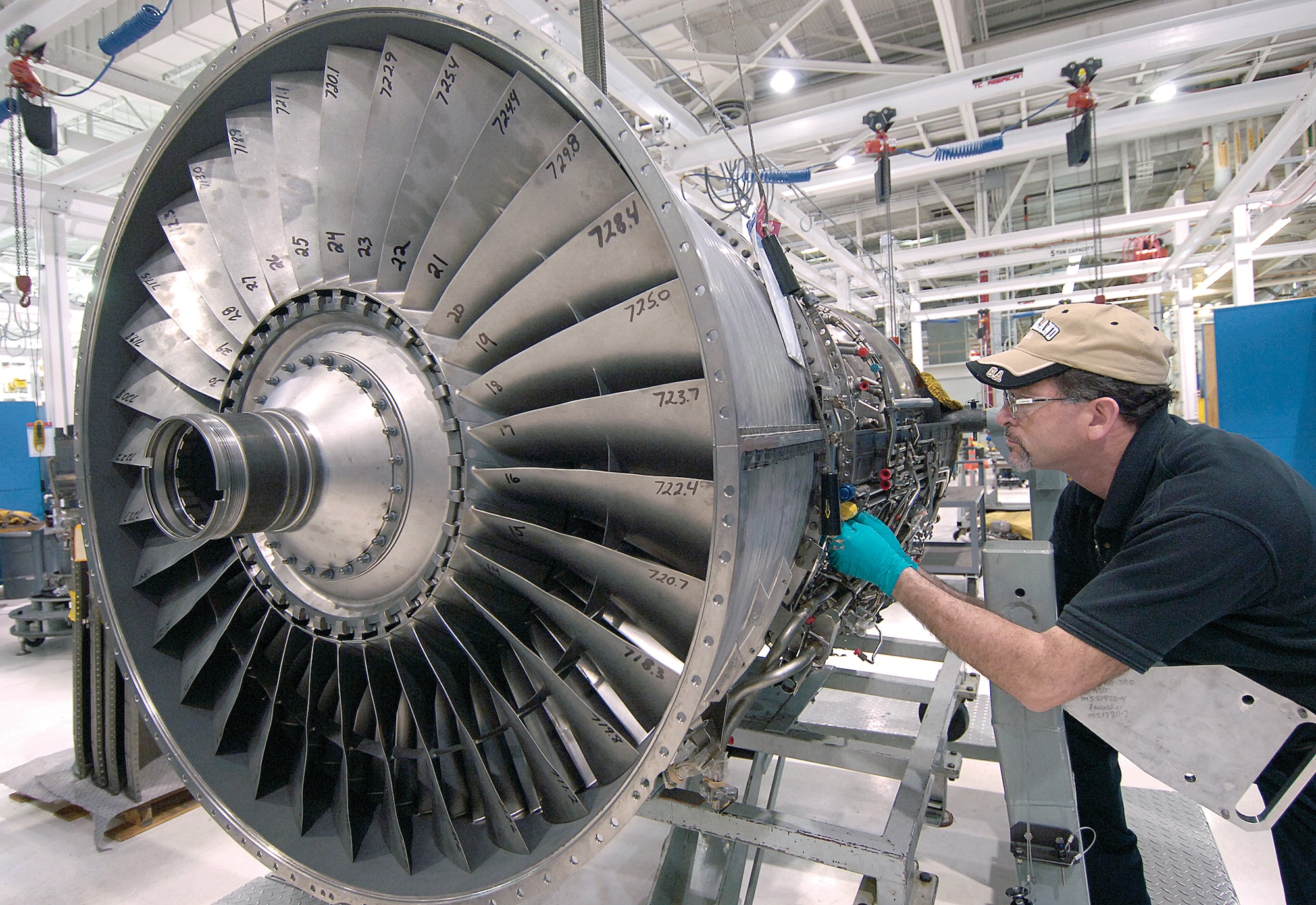 After maintenance and fan upgrades, an Egyptian F110-GE-100C engine is reassembled at Tinker recently by jet engine mechanic Terry LeBlanc. Mr. LeBlanc is one of several mechanics in the 548th Propulsion Maintenance Squadron working on the engines, 12 of which are expected to come here this year.(Air Force photo by Margo Wright)
