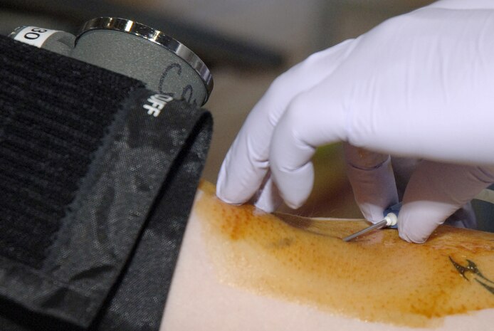 Michelle Edwards prepares to insert a needle in the arm of Airman 1st Class Tyree Johnson during the Joint Base Charleston blood drive held at the Fitness and Sports Center Feb. 3. The blood collected will be used for residents living in South Carolina. Ms. Edwards is a collection specialist with the American Red Cross Charleston Service Center and Airman Johnson is assigned to the 437th Maintenance Squadron as an avionics technician. (U.S. Air Force photo/Staff Sgt. Marie Brown)