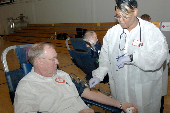 Shunta Stanley applies iodine to the arm of Jim Brickell prior to drawing his blood during the Joint Base Charleston blood drive held at the Fitness and Sports Center Feb 3. The American Red Cross Charleston Service Center comes to the base every other month to give everyone who wants to donate blood a chance to save a life. Ms. Stanley is a collections specialist with the ARC and Mr. Brickell is a base contractor with AECOM Engineer Company. (U.S. Air Force photo/Staff Sgt. Marie Brown)