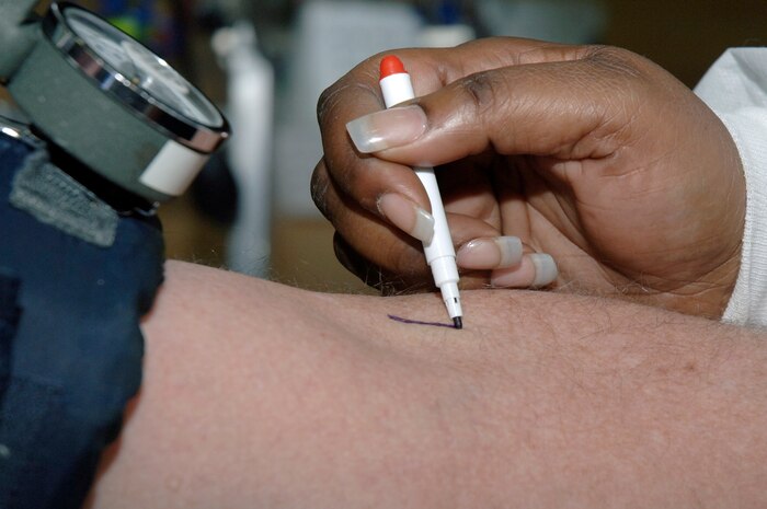 Shunta Stanley marks where a vein is located on the arm of Jim Brickell prior to drawing his blood during the Joint Base Charleston blood drive held at the Fitness and Sports Center Feb 3. For every person who donates, three lives can be saved. Ms. Stanley is a collections specialist with the American Red Cross Charleston Service Center and Mr. Brickell is a base contractor with AECOM Engineer Company. (U.S. Air Force photo/Staff Sgt. Marie Brown)