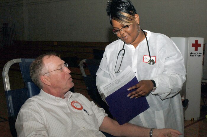 Shunta Stanley reviews paperwork with Jim Brickell during the Joint Base Charleston blood drive held at the Fitness and Sports Center Feb 3. The need for blood is always great and the American Red Cross is constantly looking for individuals willing to donate. Ms. Stanley is a collections specialist with the American Red Cross Charleston Service Center and Mr. Brickell is a base contractor with AECOM Engineer Company. (U.S. Air Force photo/Staff Sgt. Marie Brown)