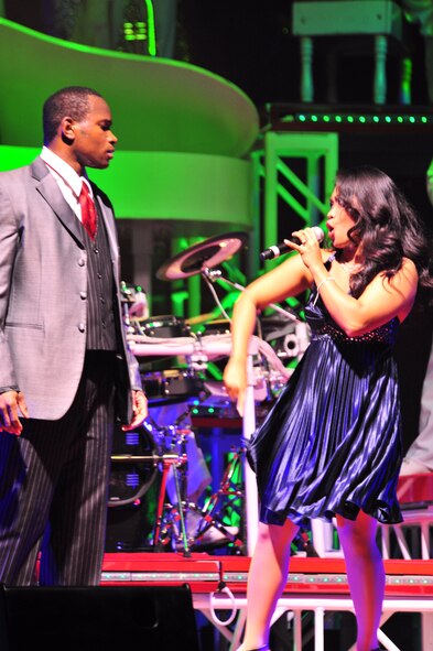 Sumter, S.C. - Staff Sgt. Wendell Boone (left) and Senior Airman Jennifer Bone, performers with Tops in Blue, sing during a performance for the Sumter community at the Patriot Hall Auditorium Feb 3. Tops in Blue, an ensemble made up of the most-talented Airmen in the force, entertains military and civilian audiences around the globe with music. Their tour encompasses more than 120 shows worldwide and includes numerous shows for deployed Airmen in the Southwest Asia area of operations. (U.S. Air Force photo/Airman 1st Class Amber E. N. Jacobs)