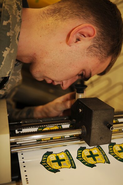 Airman 1st Class Raymond Bettley, 4th Equipment Maintenance Squadron aircraft structural maintenance apprentice, aligns patches for cutting on Seymour Johnson Air Force Base, N.C., Feb. 3, 2010. The patches must be lined up with the cross-hairs to properly cut out the shape. Bettley is from Hamden, Conn. (U.S. Air Force photo/Senior Airman Ciara Wymbs) 