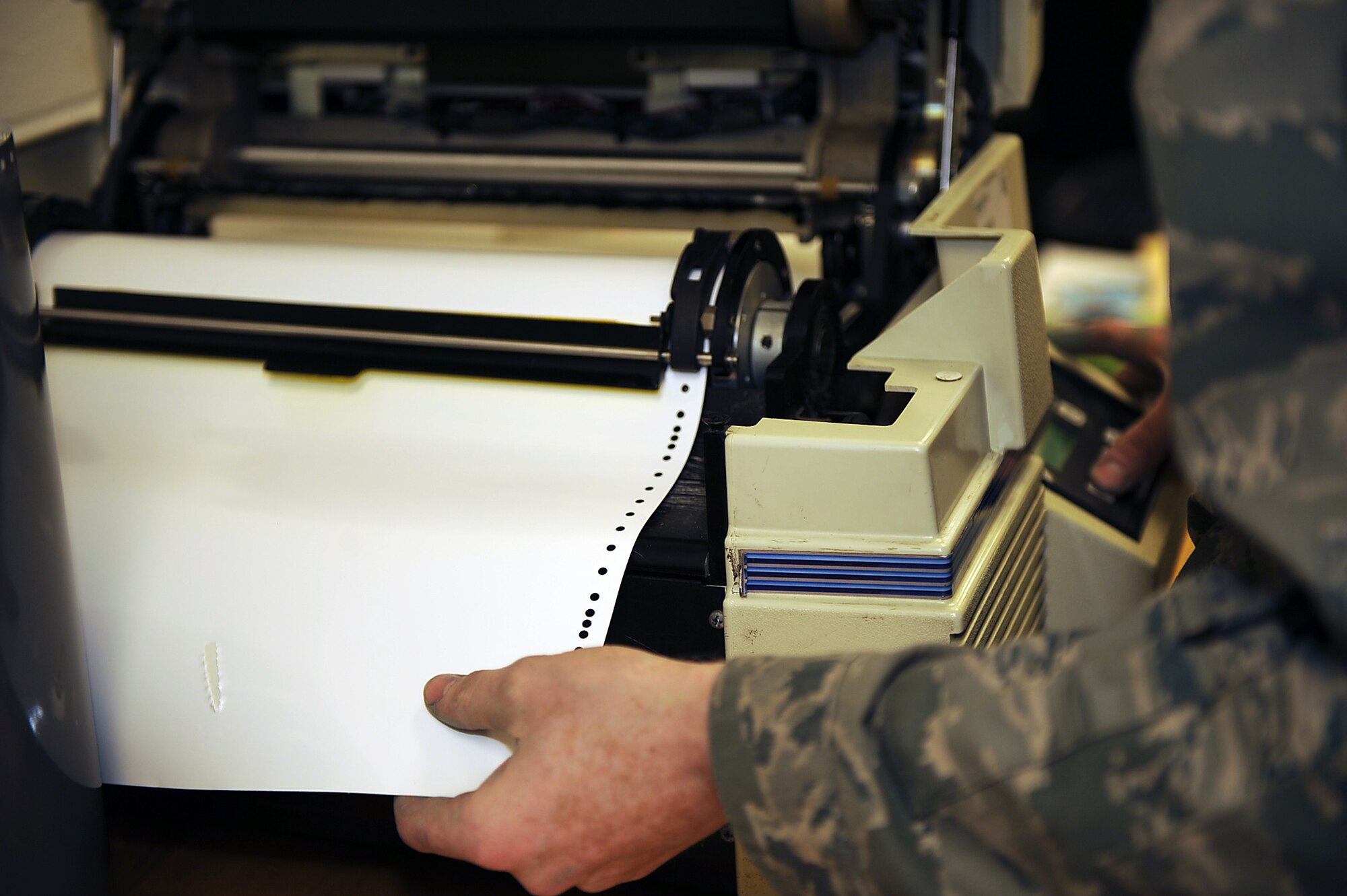 Airman 1st Class Raymond Bettley, 4th Equipment Maintenance Squadron aircraft structural maintenance apprentice, aligns vinyl for printing of decals and patches on Seymour Johnson Air Force Base, N.C., Feb. 3, 2010. The decals and patches printed represent the home station and unit the jets are from. Bettley is from Hamden, Conn. (U.S. Air Force photo/Senior Airman Ciara Wymbs)  