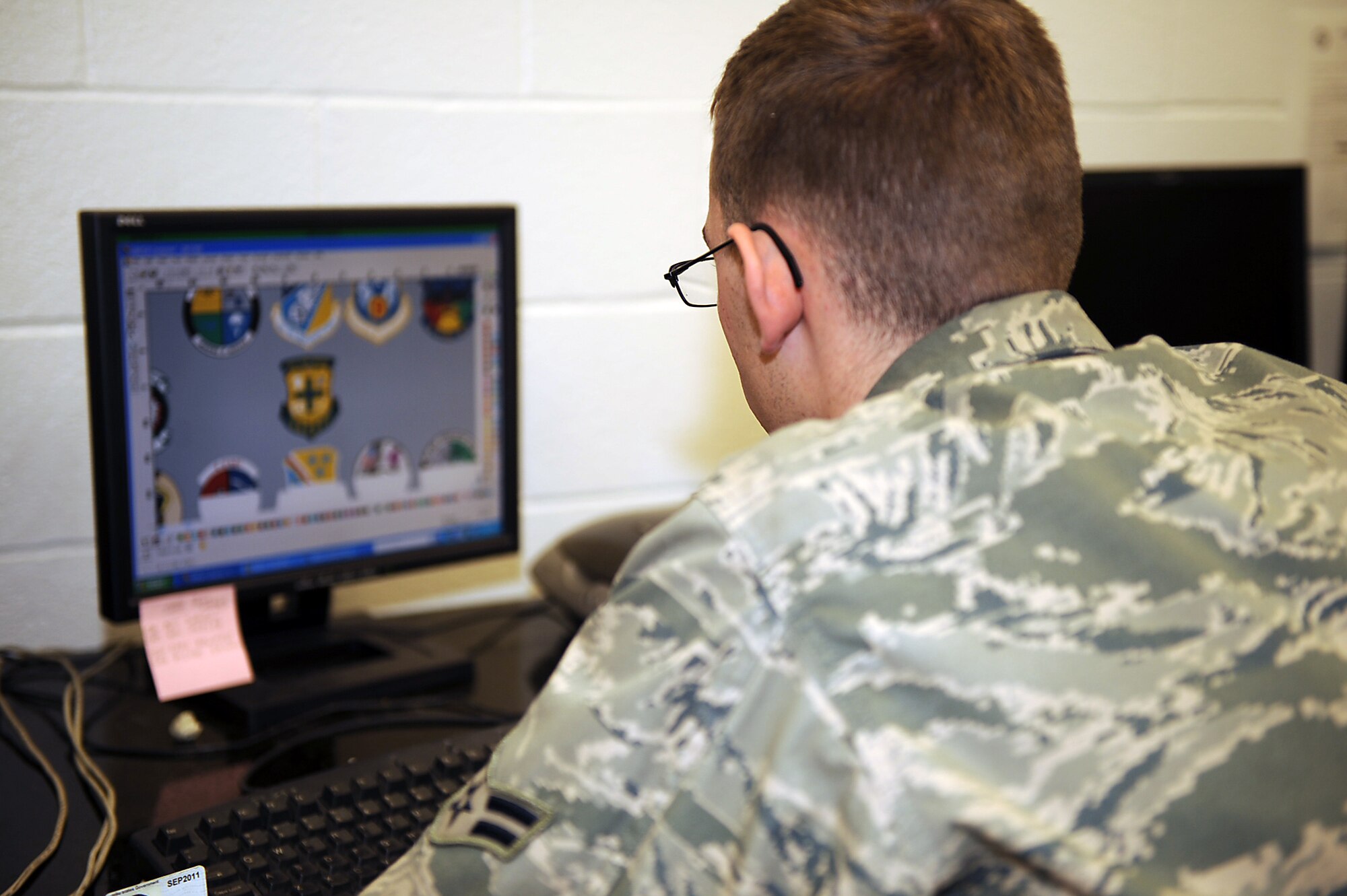 Airman 1st Class Raymond Bettley, 4th Equipment Maintenance Squadron aircraft structural maintenance apprentice, looks for patches that need to be printed on Seymour Johnson Air Force Base, N.C., Feb. 3, 2010. All patches seen on the F-15E's here including static displays are printed, cut out and applied by the 4th EMS. Bettley is from Hamden, Conn. (U.S. Air Force photo/Senior Airman Ciara Wymbs)    